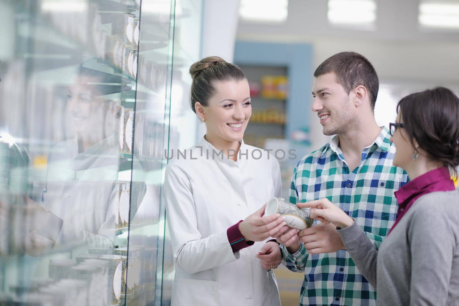 young pharmacist suggesting medical drug to buyer in pharmacy drugstore