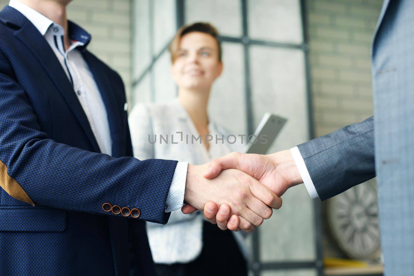 Business people shaking hands, finishing up a meeting by tsyhun