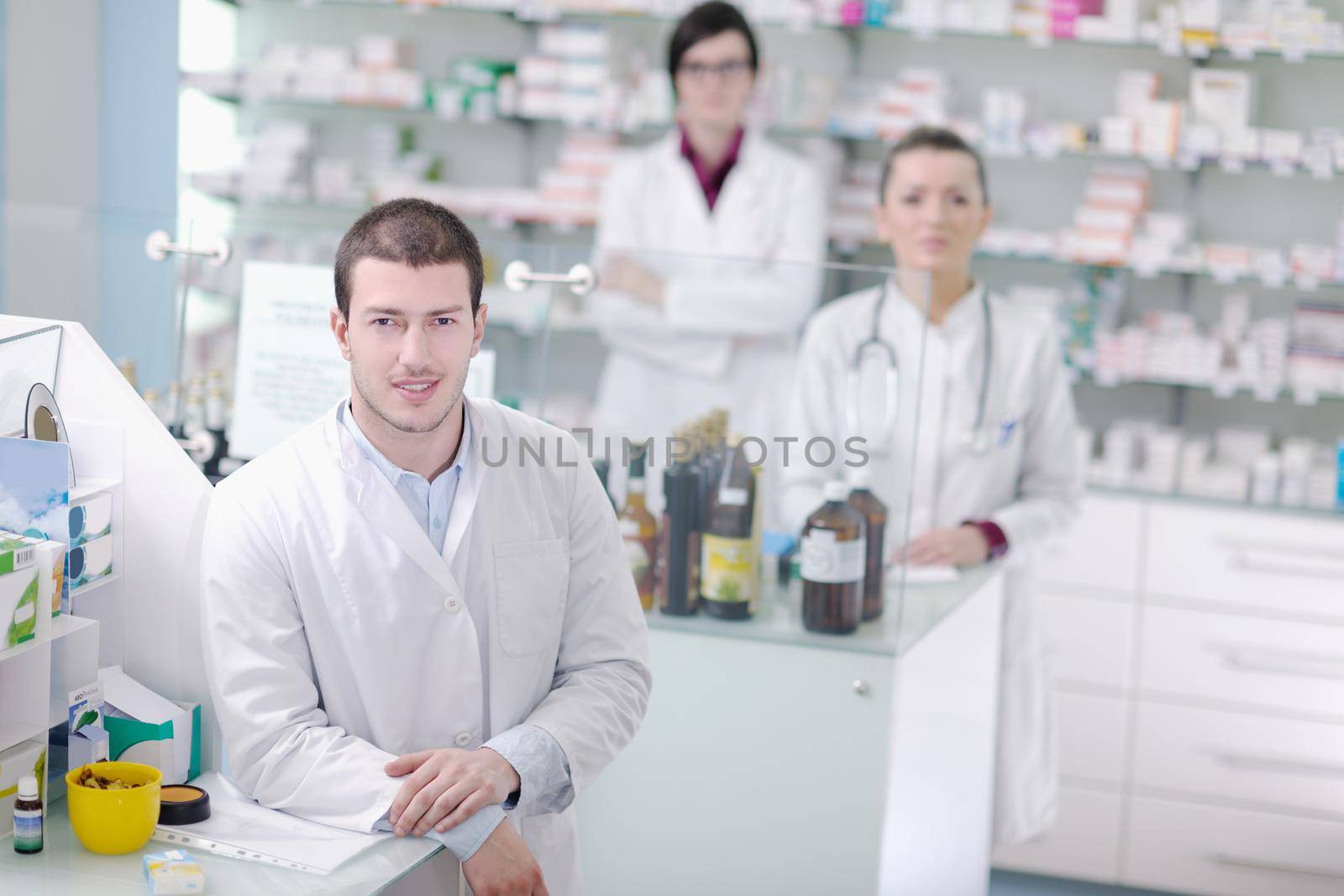 team of  pharmacist chemist woman and man  group  standing in pharmacy drugstore