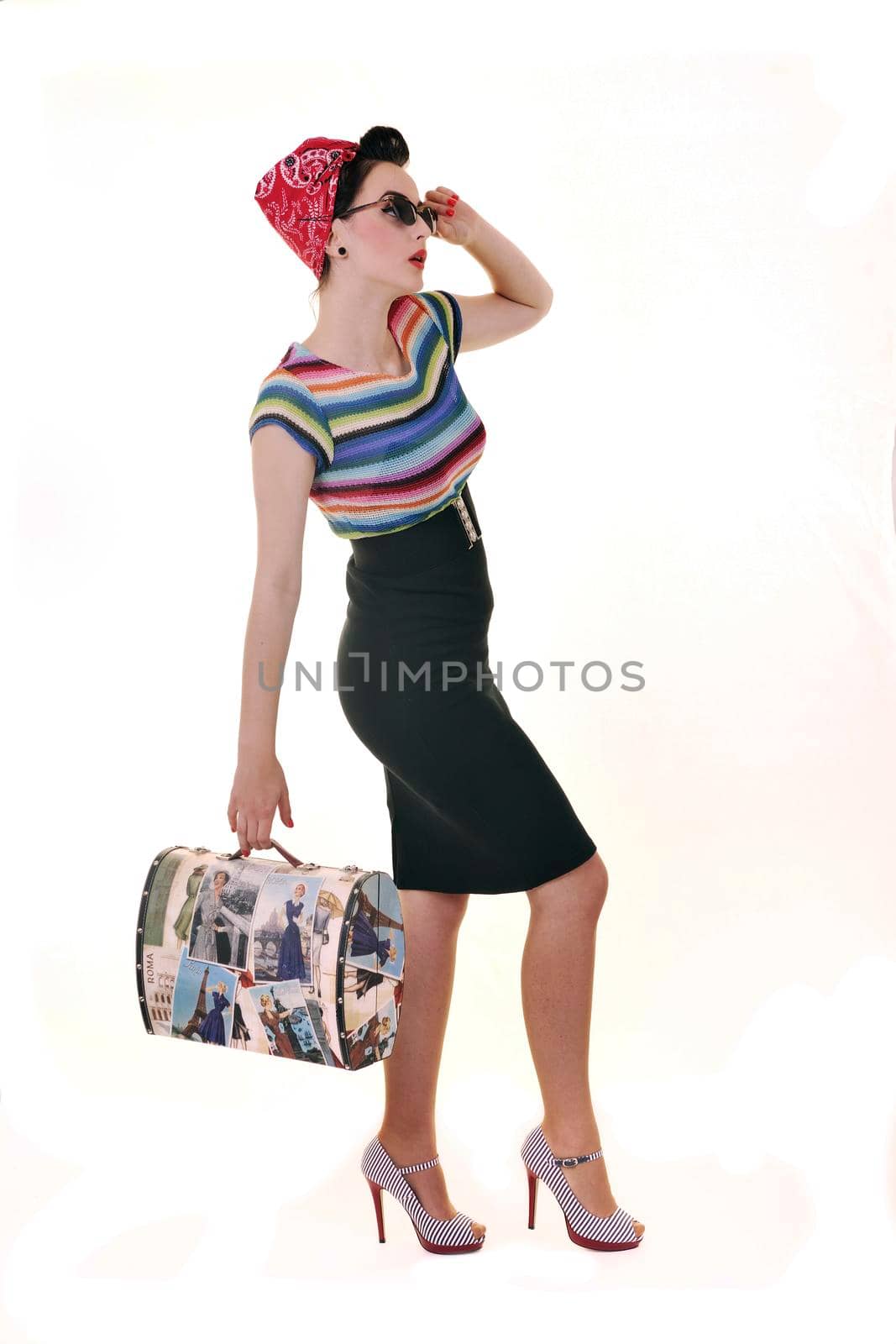 pretty young happy woman with travel bag waiting and posing isolated on white in studio