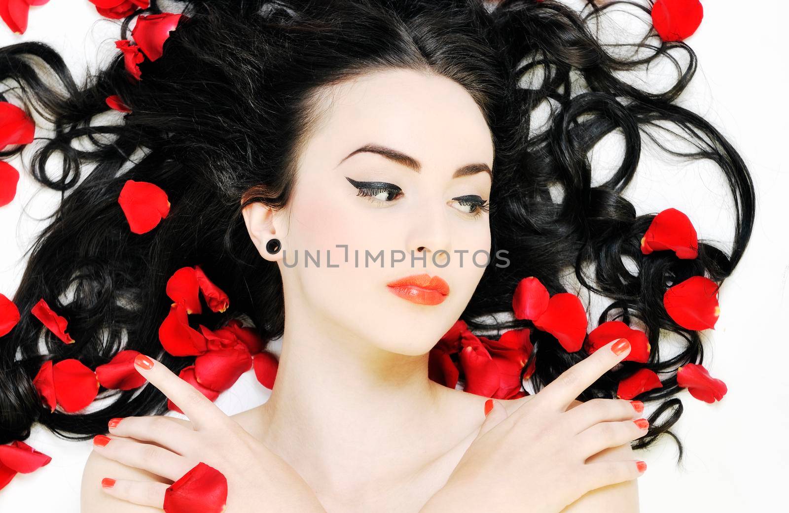 beautiful young nude woman with roses isolated on white representing beauty concept