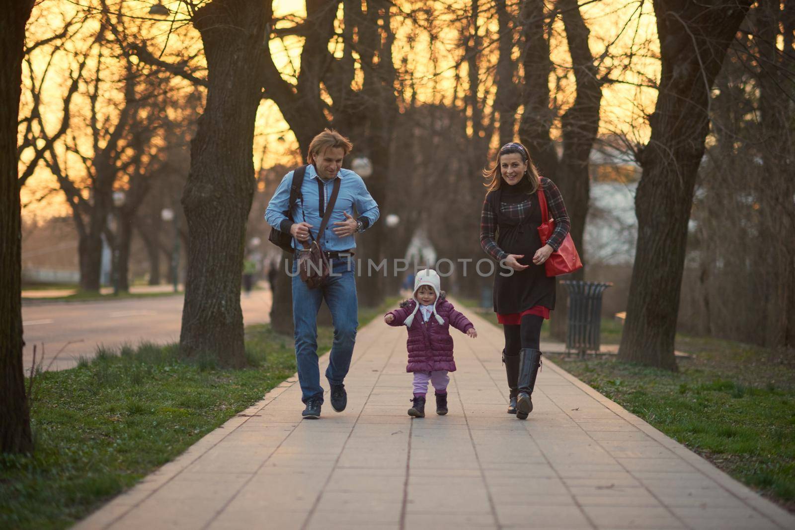 young pregnant couple have fun and relax by dotshock