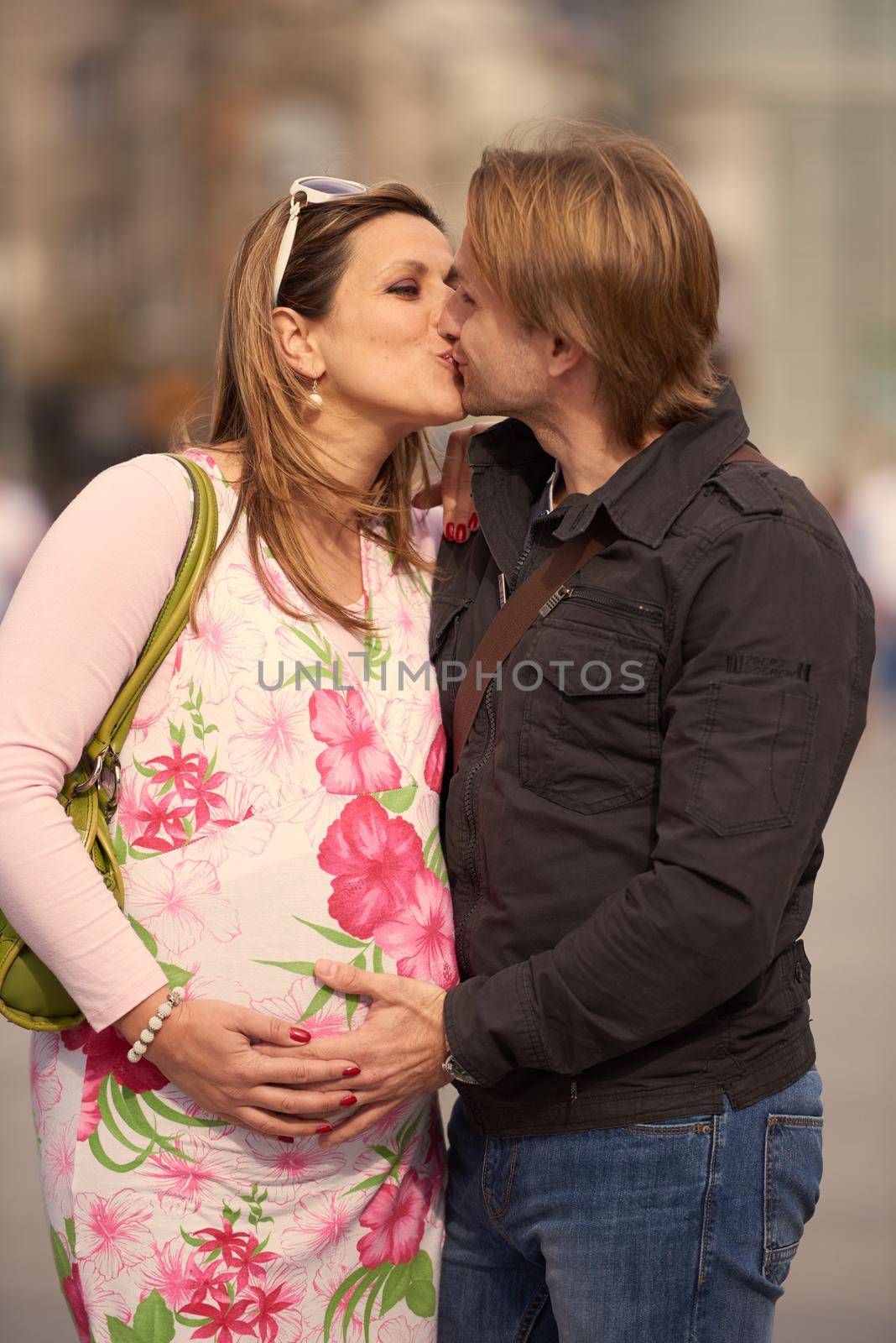 young pregnant couple have fun and relax by dotshock
