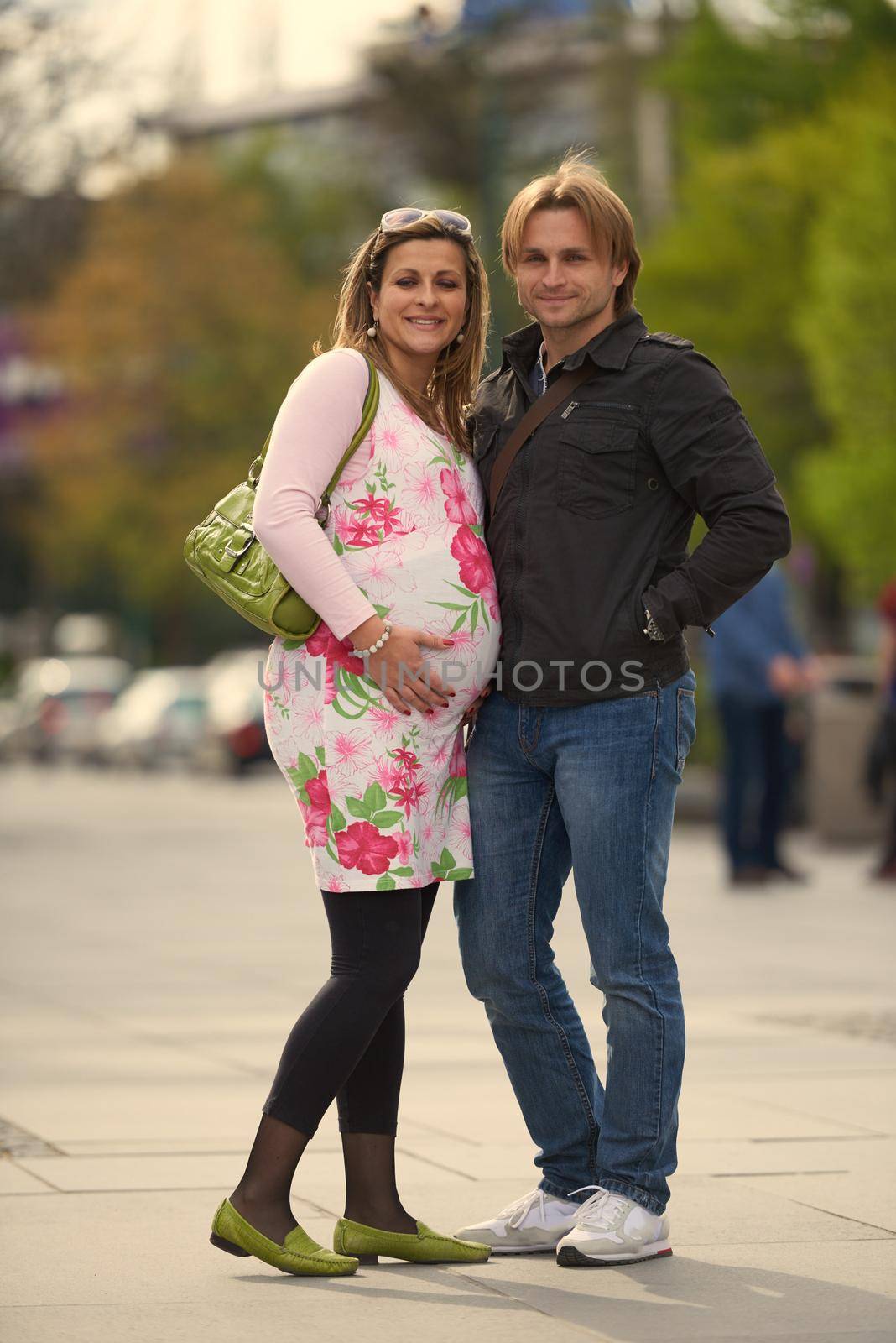 young pregnant couple have fun and relax by dotshock