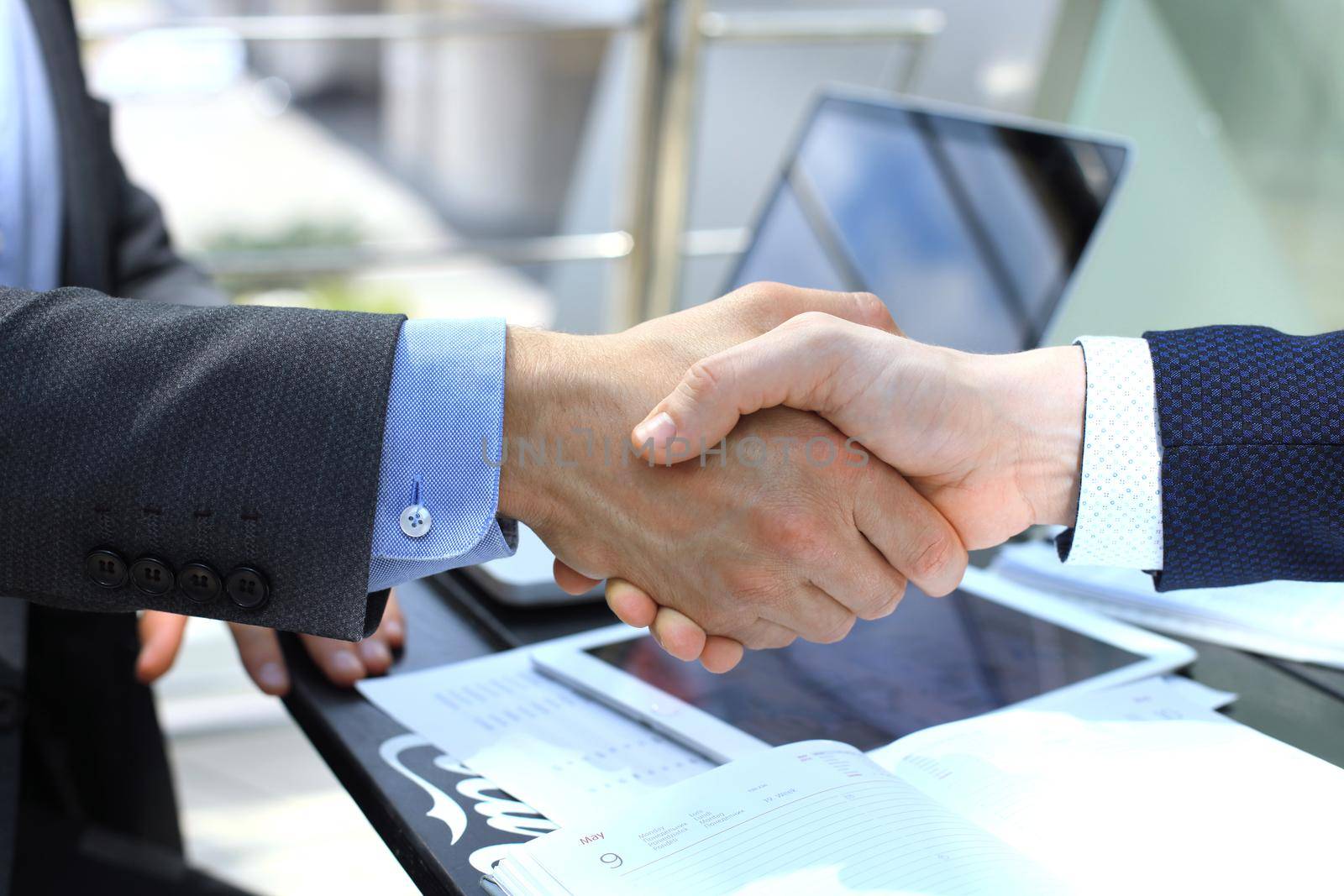 Business people shaking hands, finishing up a meeting by tsyhun