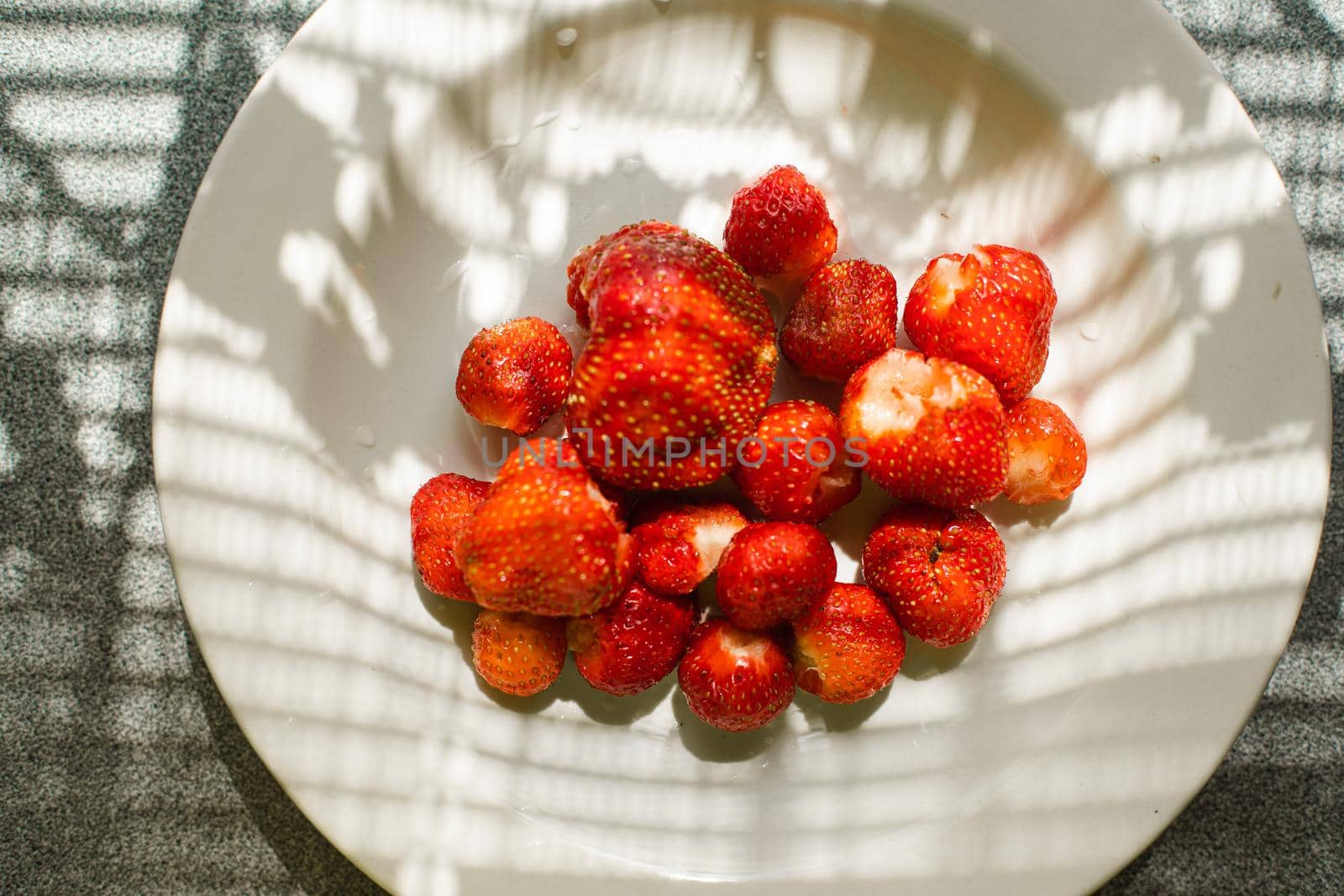 Fresh delicious strawberries in a white bowl by StudioLucky