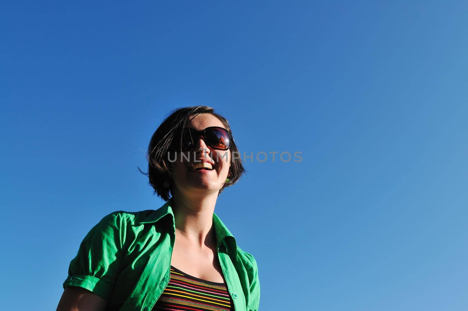 young beautiful brunette woman jump outdoor in fashion clothing and sunglasses