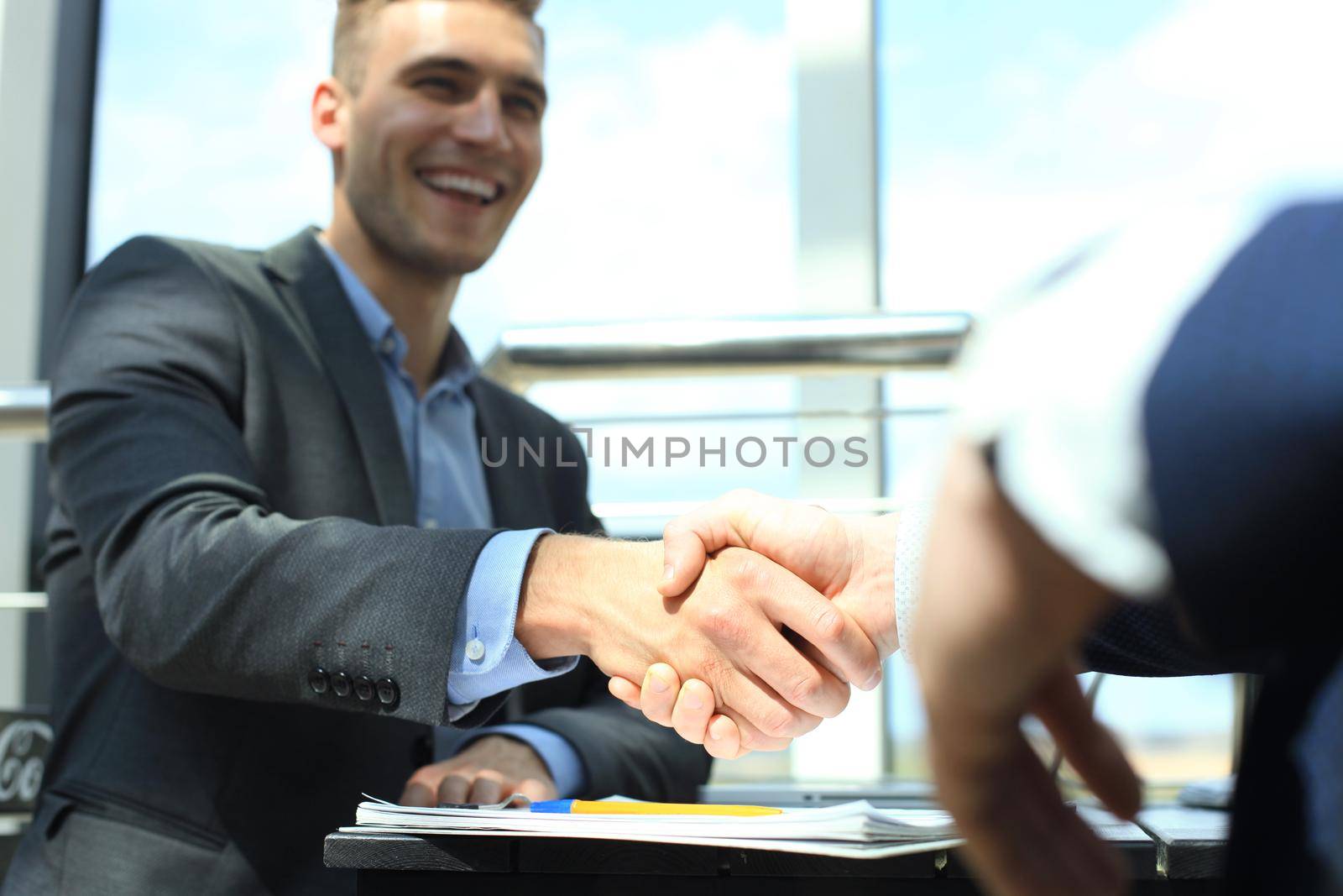 Business people shaking hands, finishing up a meeting by tsyhun