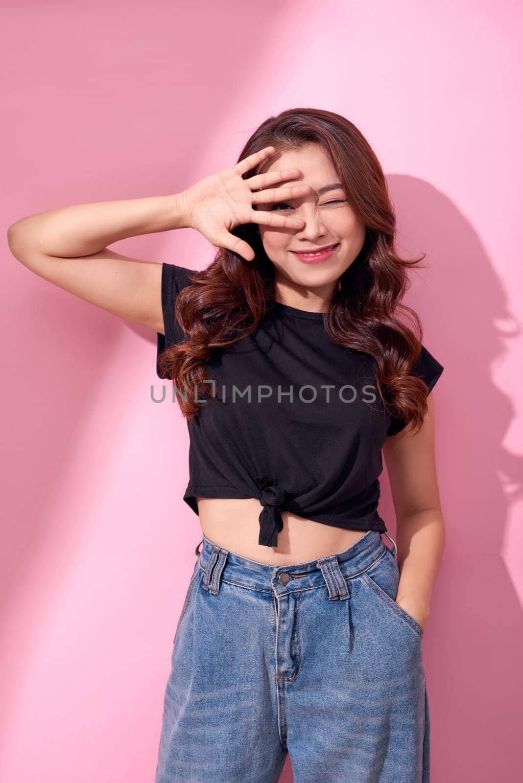 lifestyle, beauty and people concept: Young cute smiling girl over pink background