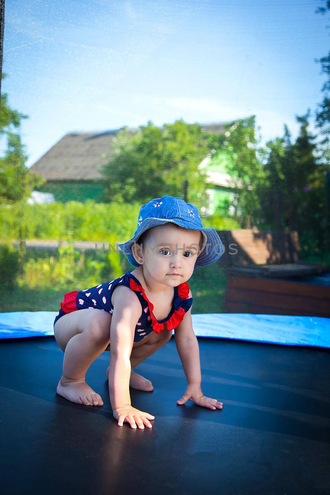 Little eighteen-month-old girl in Panama trains to jump on the trampoline