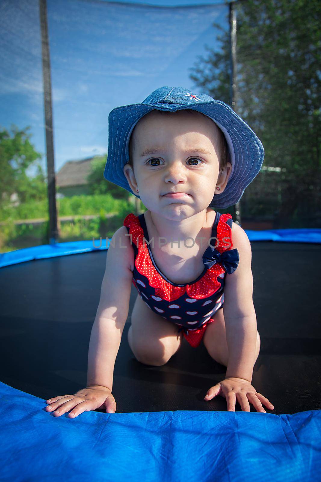 A small child posing on a trampoline