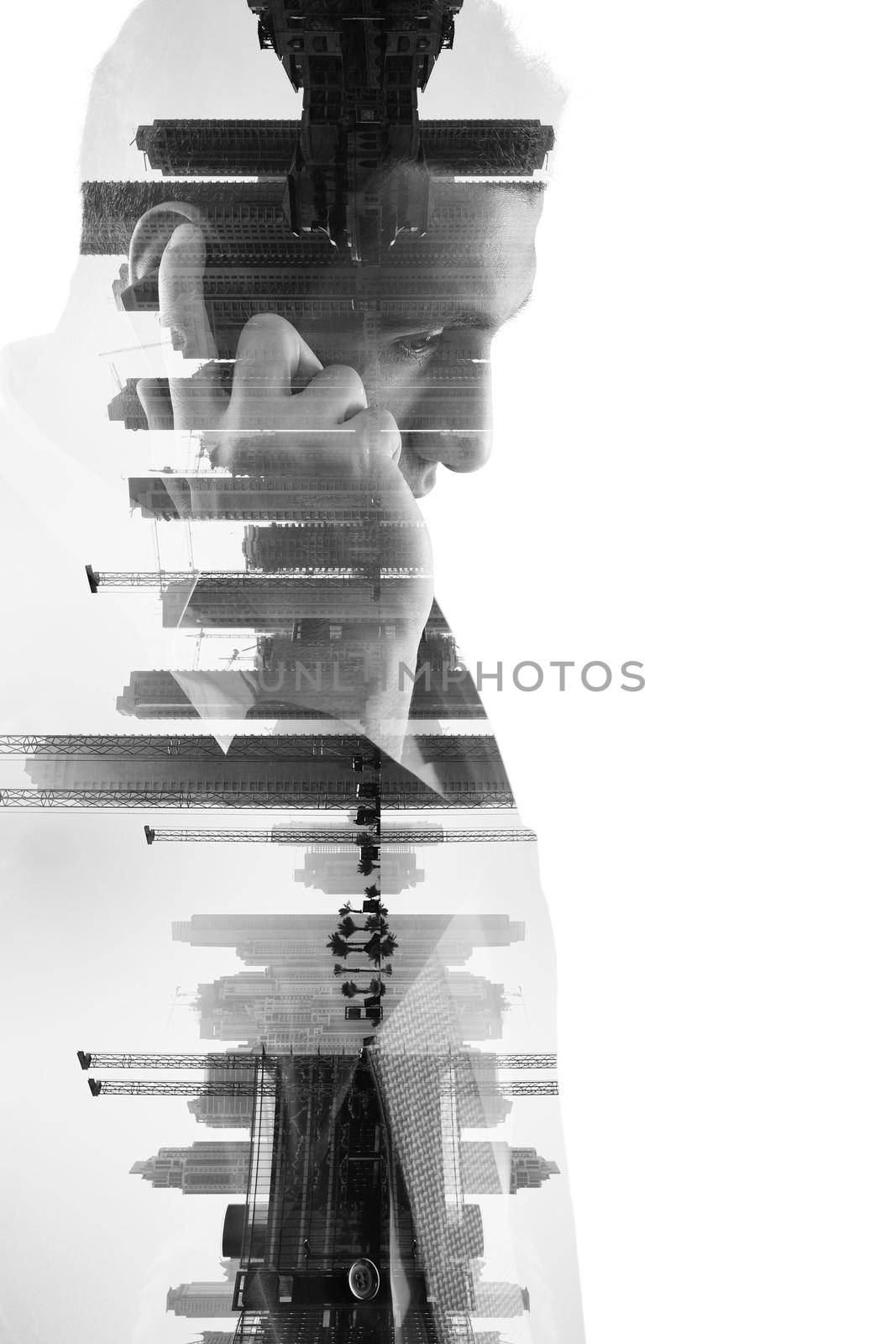 double exposure of business man with  mobile phone and city buildings by dotshock