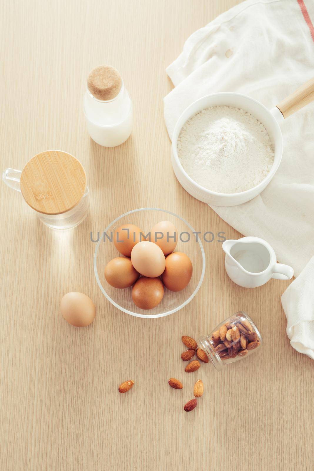 recipe ingredients : eggs, flour, milk, almonds, banana on white background