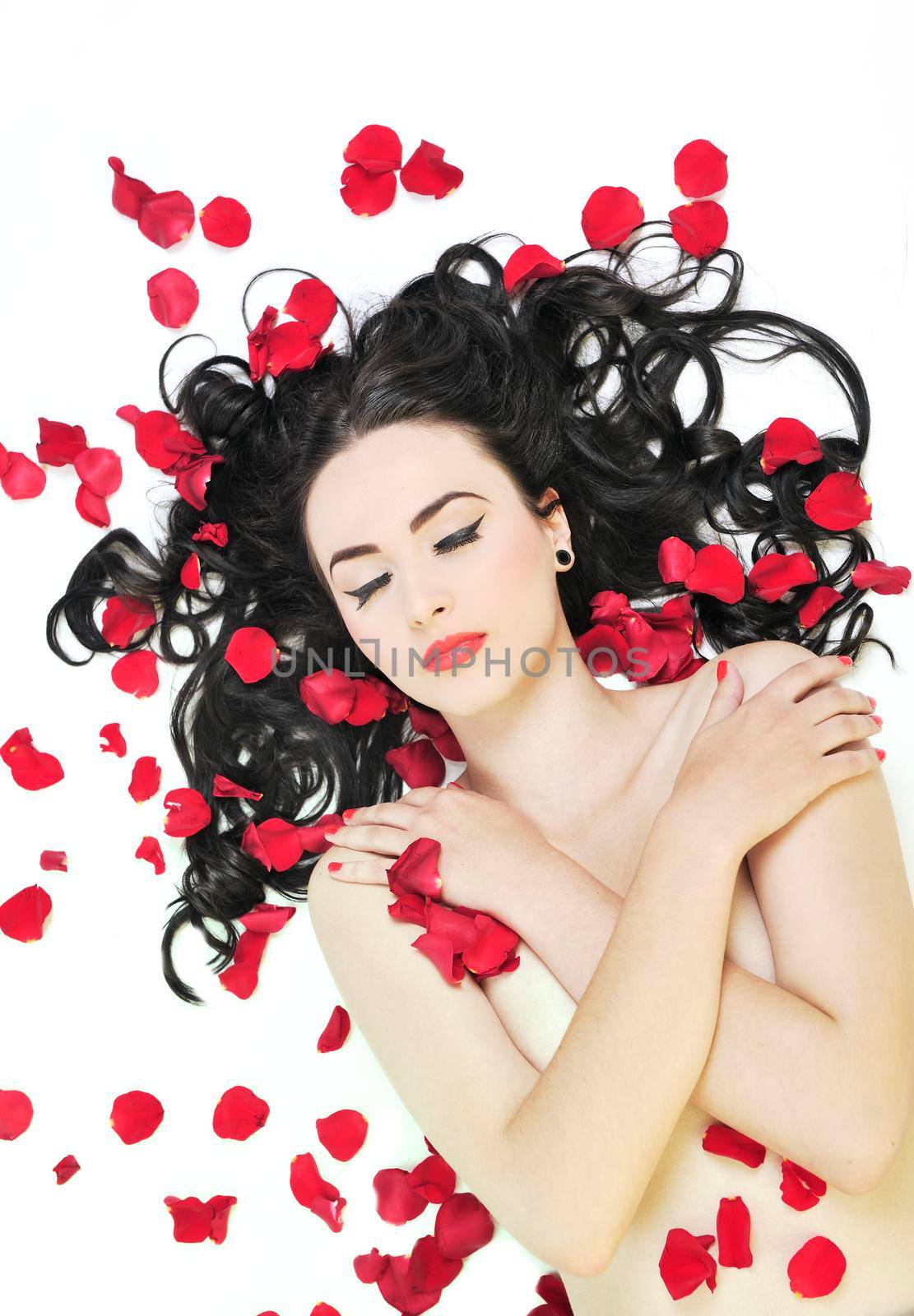 beautiful young nude woman with roses isolated on white representing beauty concept