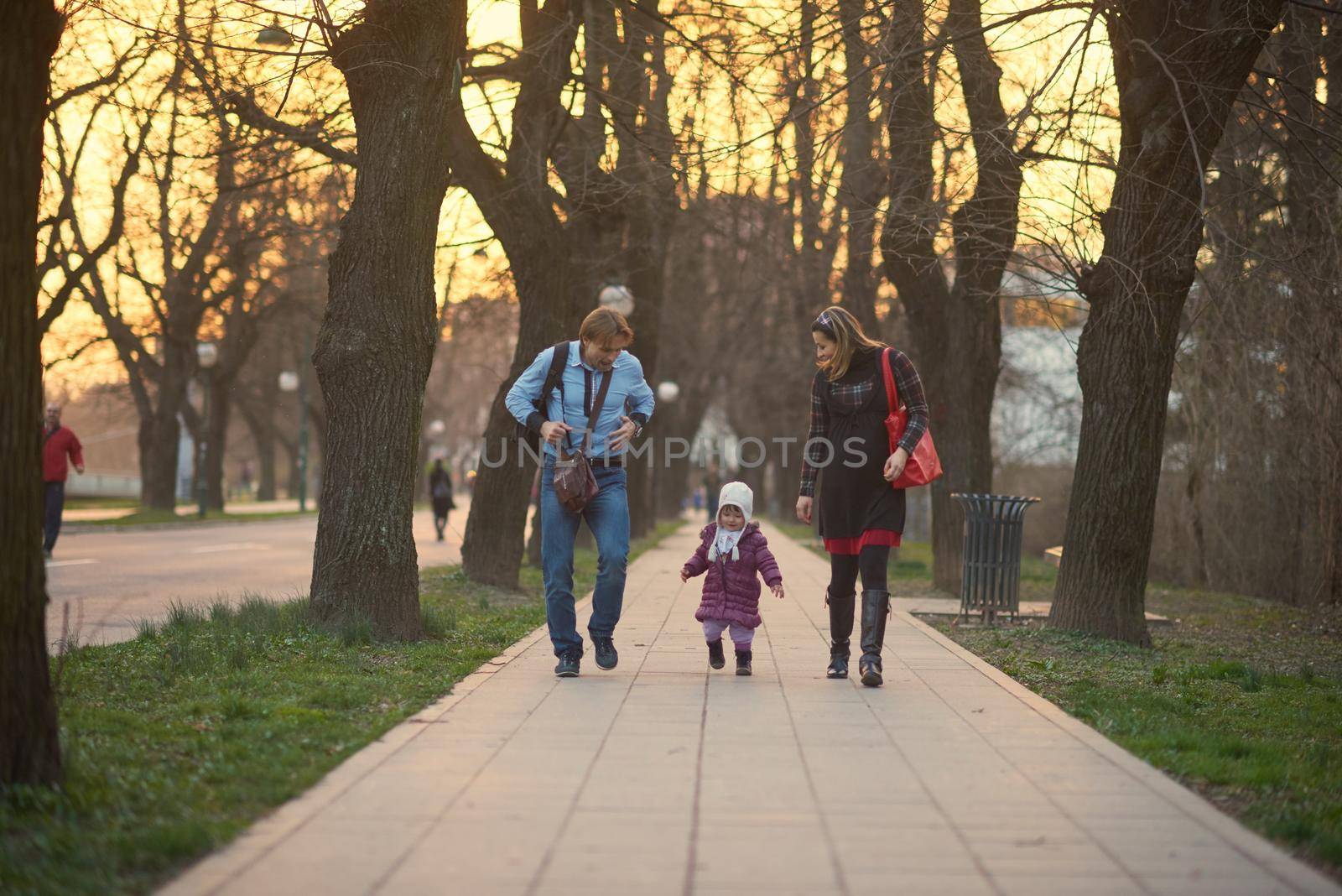 Happy and young pregnant couple have fun and relax outdoor