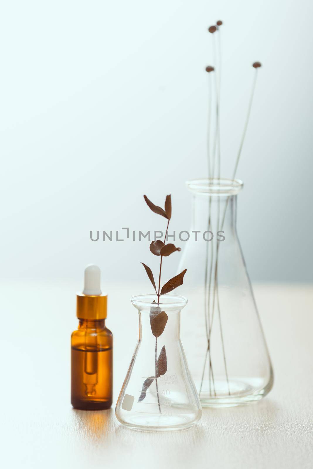 Cosmetic bottle stock images. Brown cosmetic bottle with batcher. Vials on a white background by makidotvn