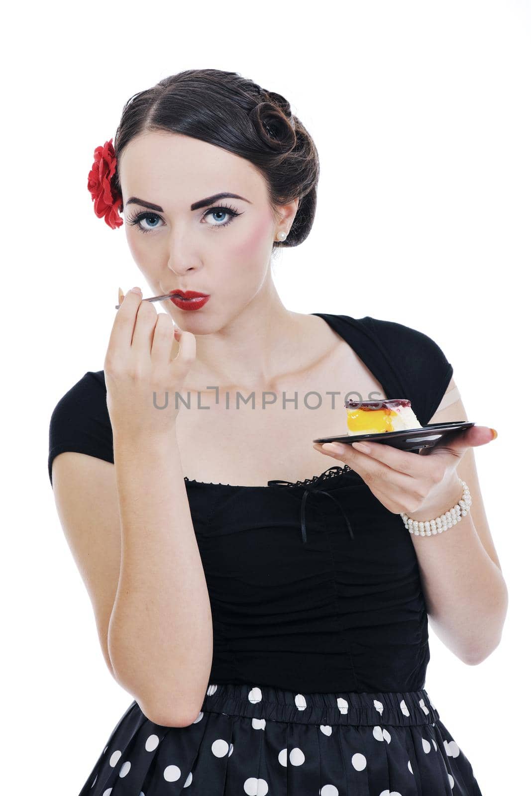 beautiful young retro pinup  woman eat sweet cake food isolated on white iin studio, representing diet and healthy concept