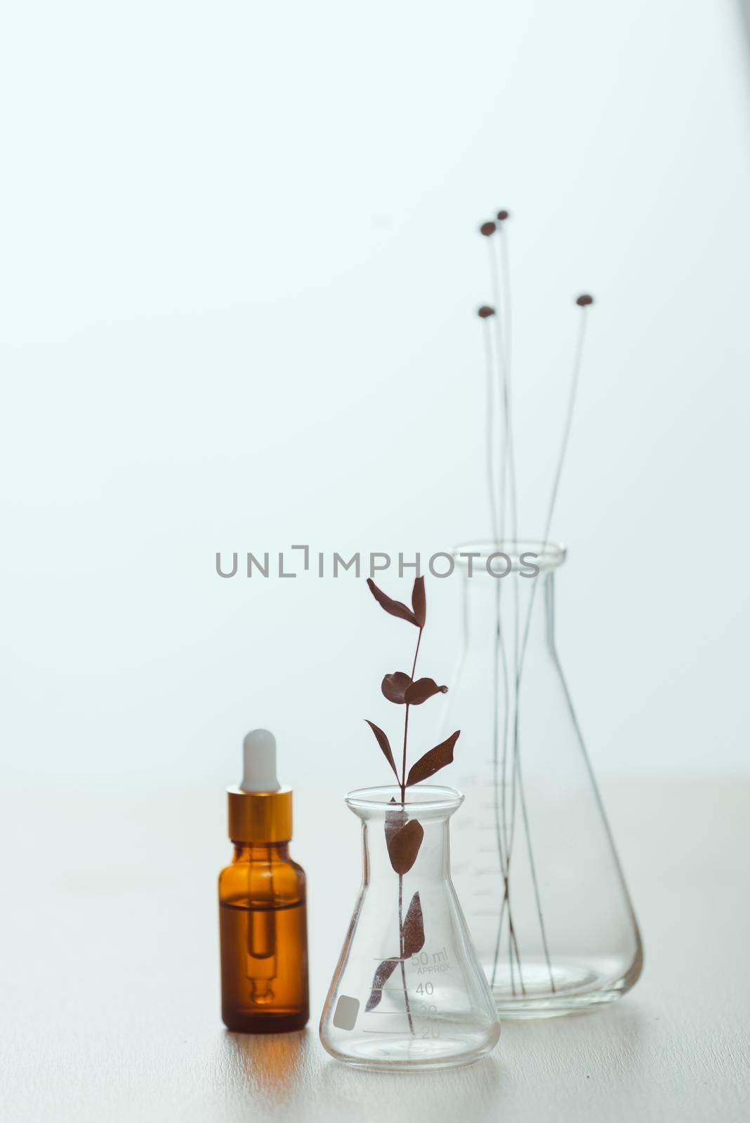Cosmetic bottle stock images. Brown cosmetic bottle with batcher. Vials on a white background