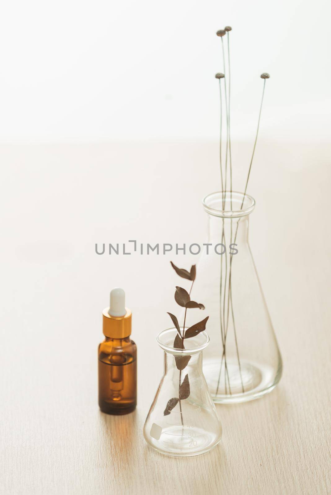 Cosmetic bottle stock images. Brown cosmetic bottle with batcher. Vials on a white background by makidotvn