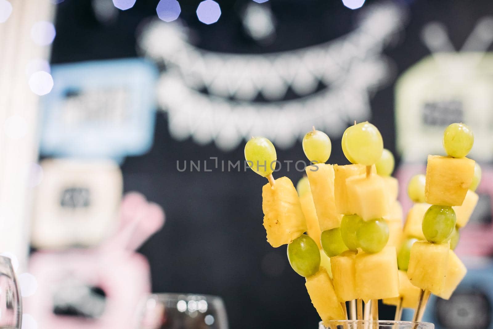 picture focused on fresh fruit grape and pineapple snack on sticks