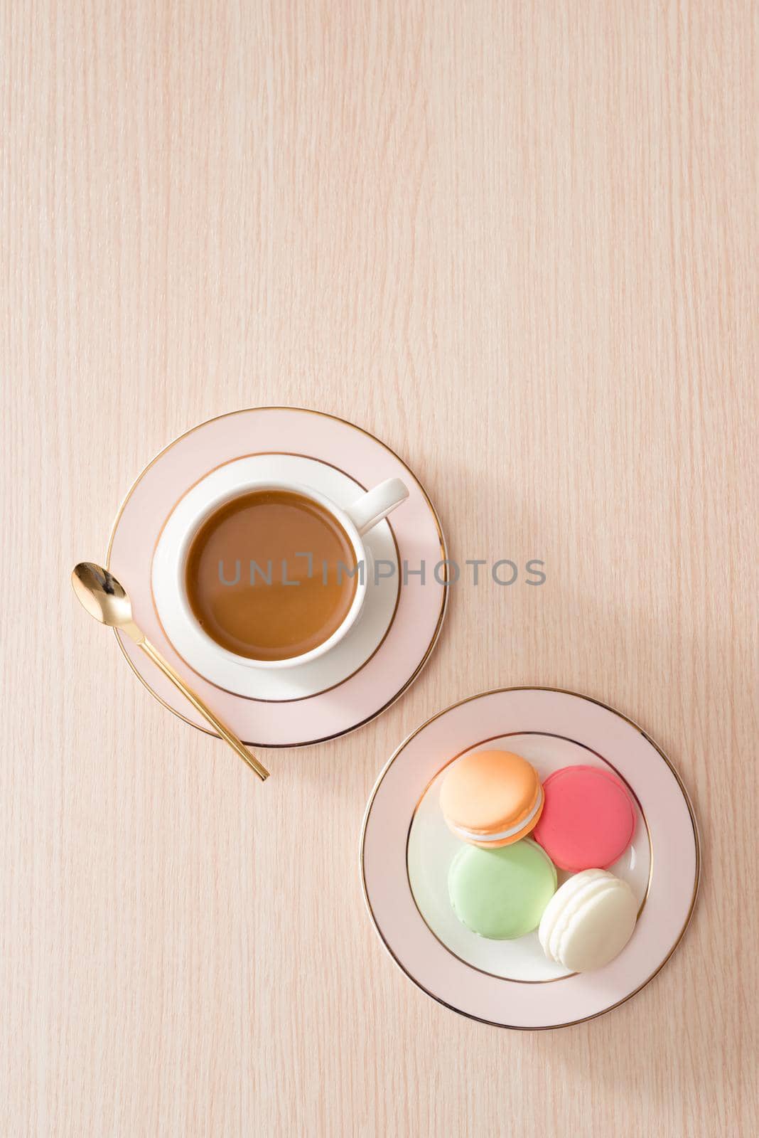 Cup of coffee with macaroons on wooden background by makidotvn