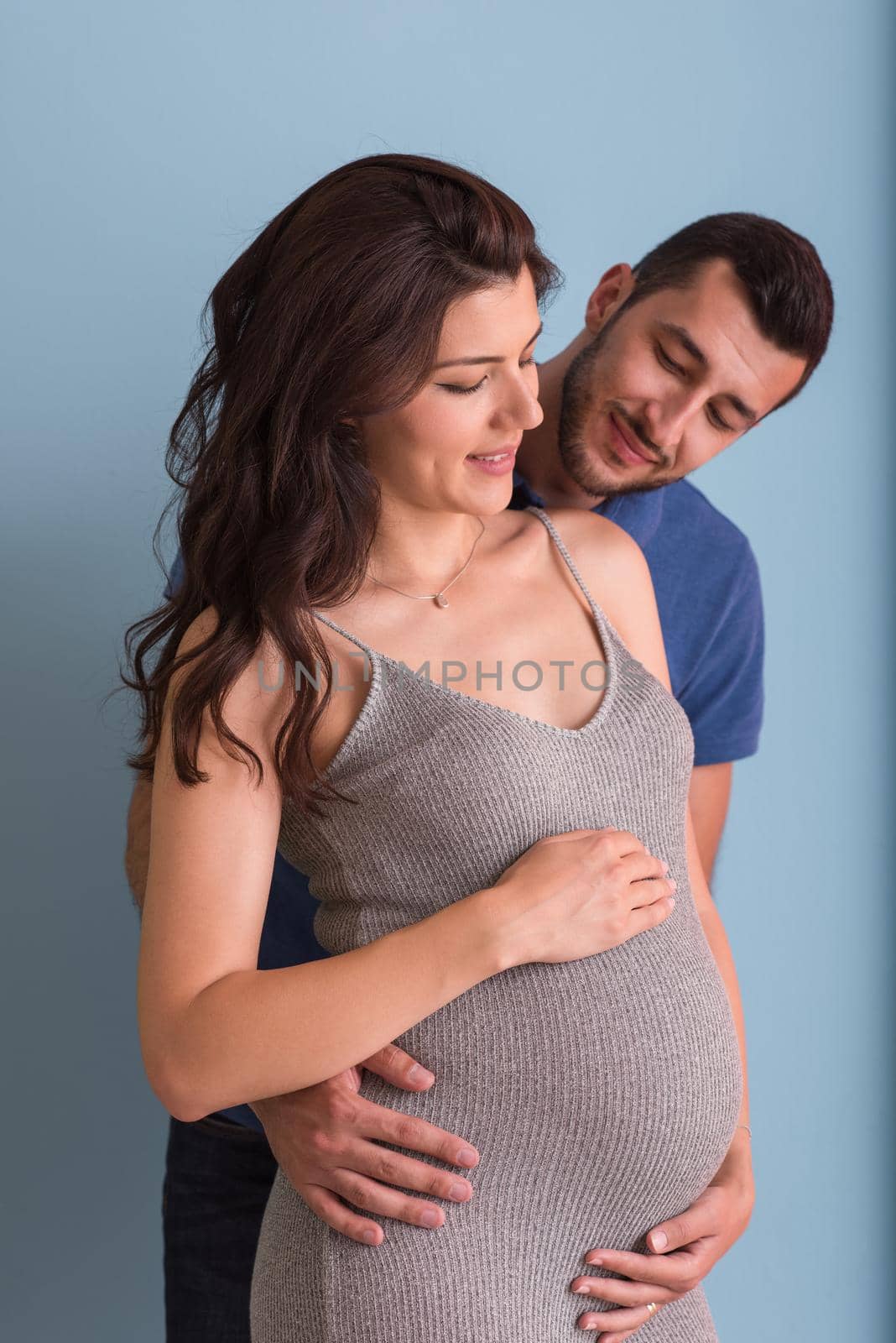 pregnant couple  isolated over blue background by dotshock