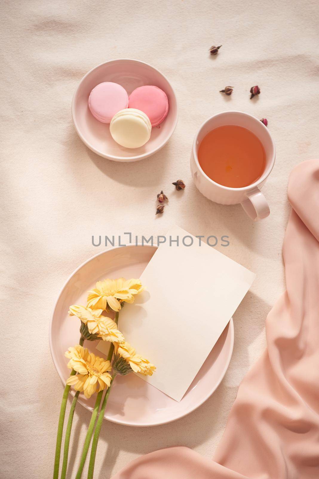 Tea cup with Rose tea and fresh  flower and macarons on white background by makidotvn