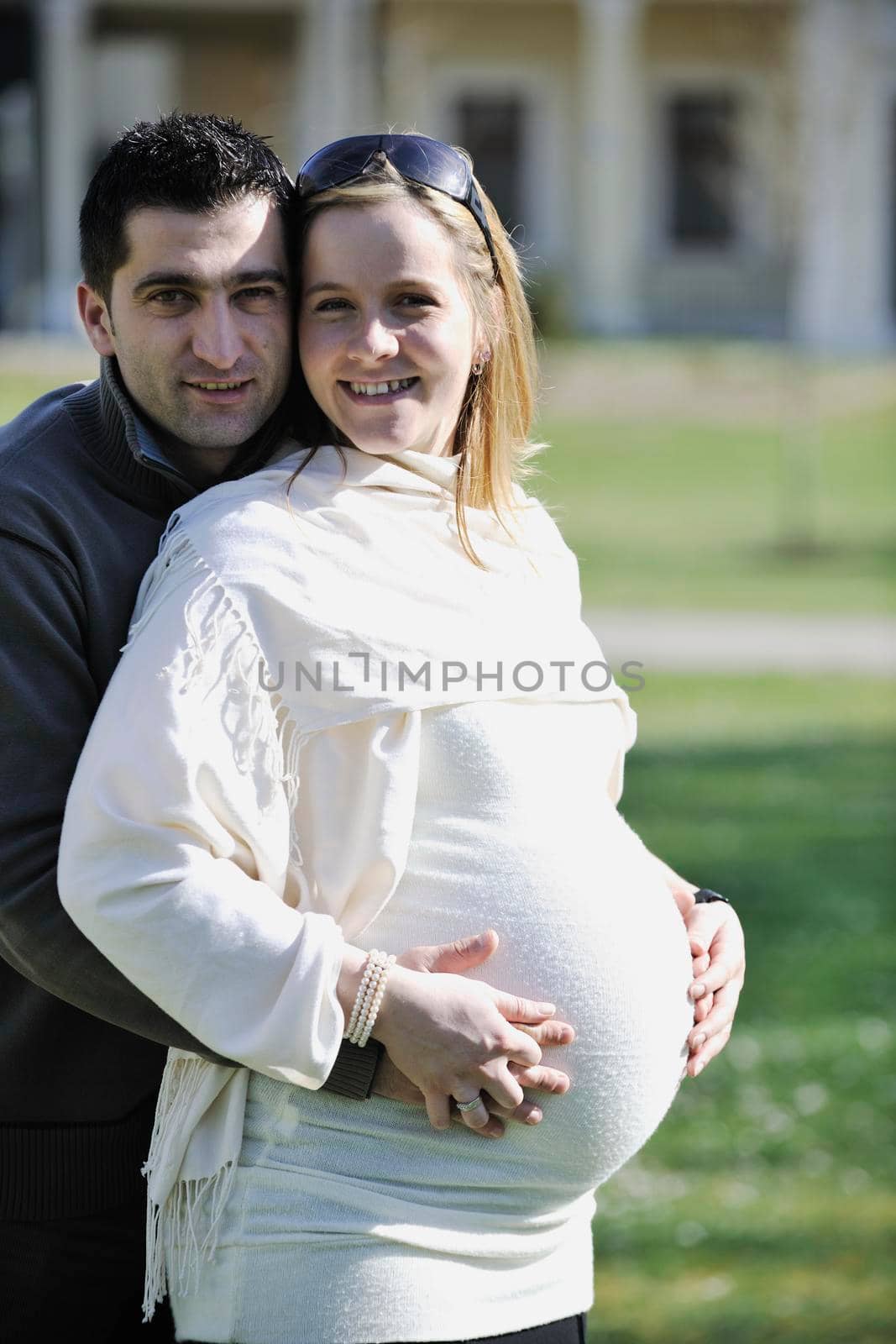 happy young married family couple outdoor in nature have fun and waiting baby and representing young family growth and pregnancy concept