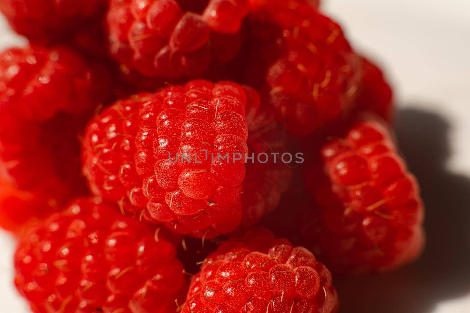 Beautiful raspberries isolated on a white background. Cut out, close up. Background and picture for postcard by StudioLucky