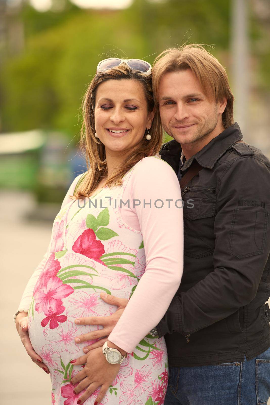 young pregnant couple have fun and relax by dotshock
