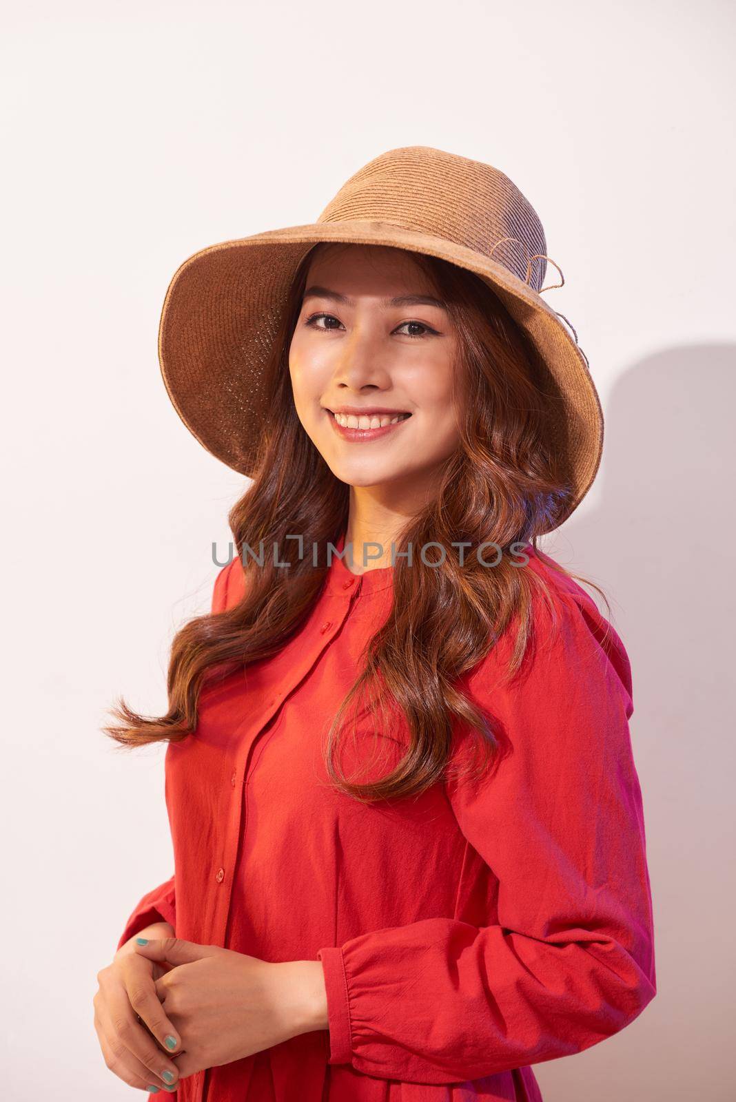 Woman wearing a straw hat and smiling. by makidotvn