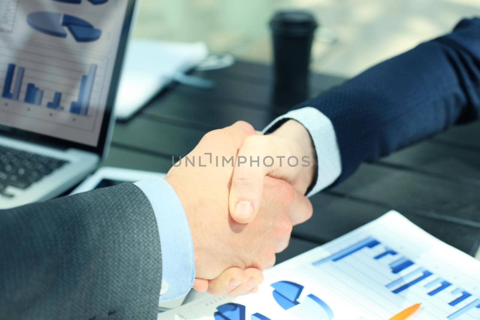 Business people shaking hands, finishing up a meeting by tsyhun