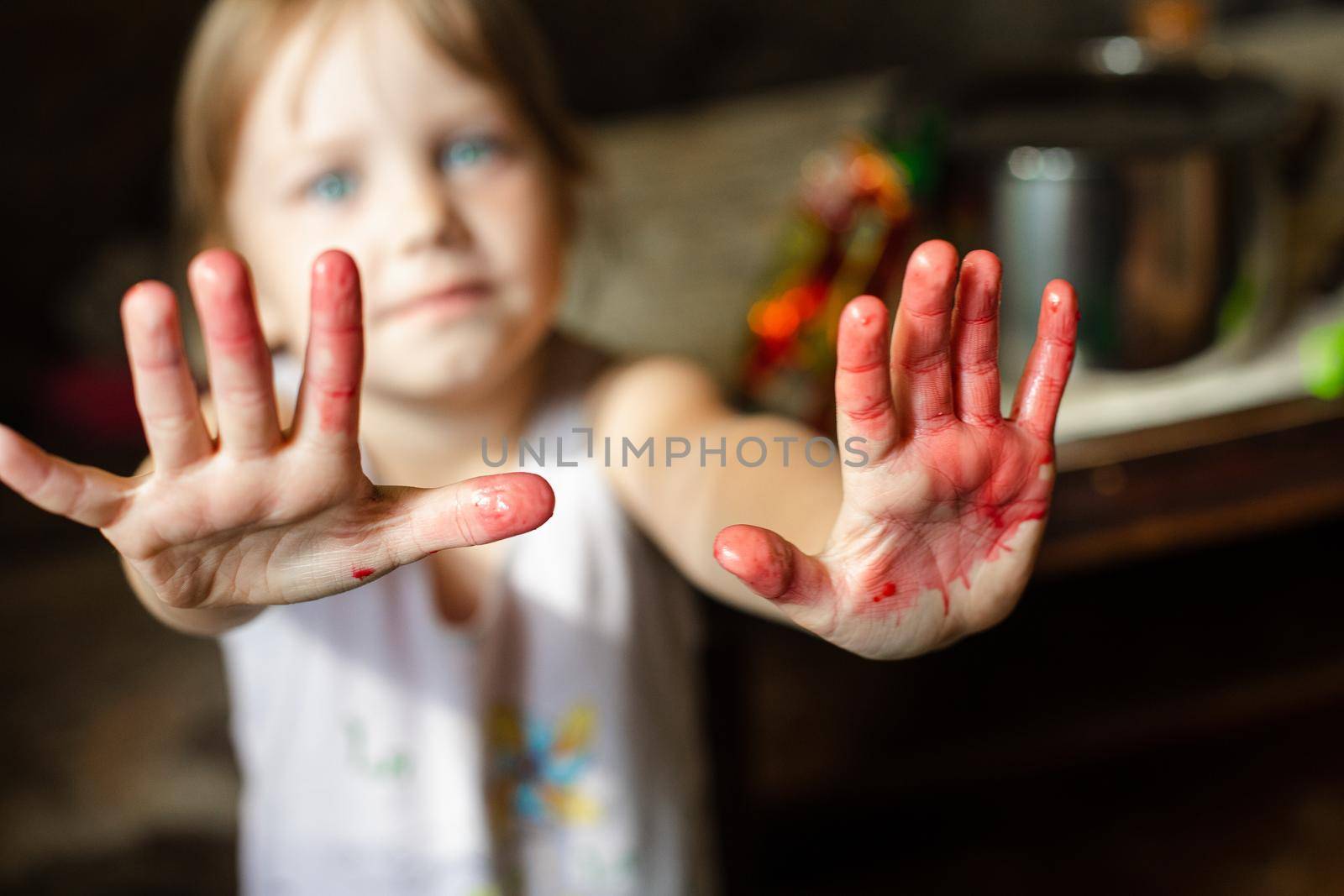 Little kid showing her hands painted in bright colors by StudioLucky