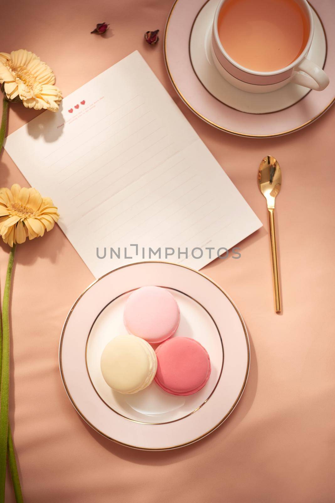Envelope, flowers, and macarons with cup of tea  by makidotvn