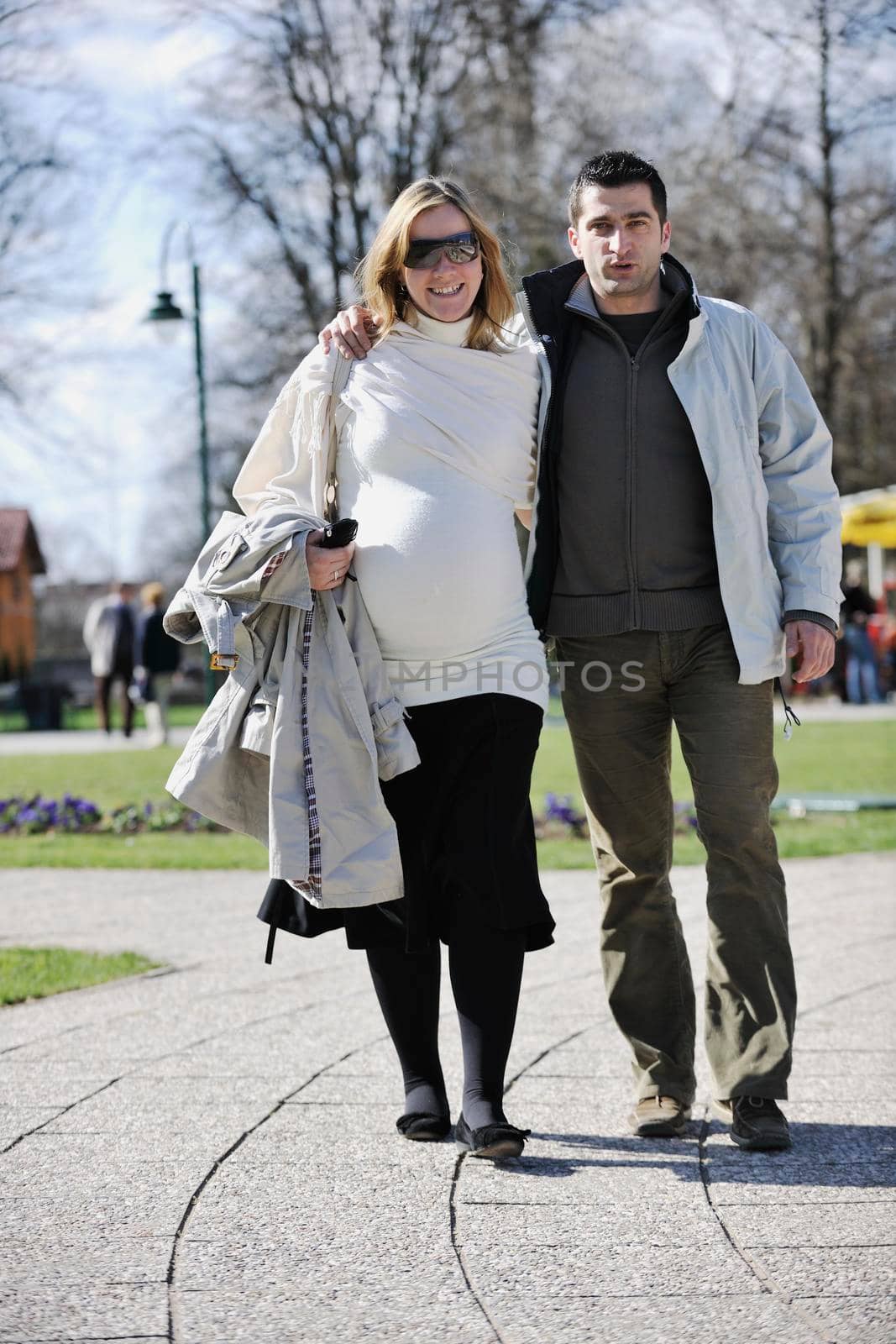 happy young married family couple outdoor in nature have fun and waiting baby and representing young family growth and pregnancy concept