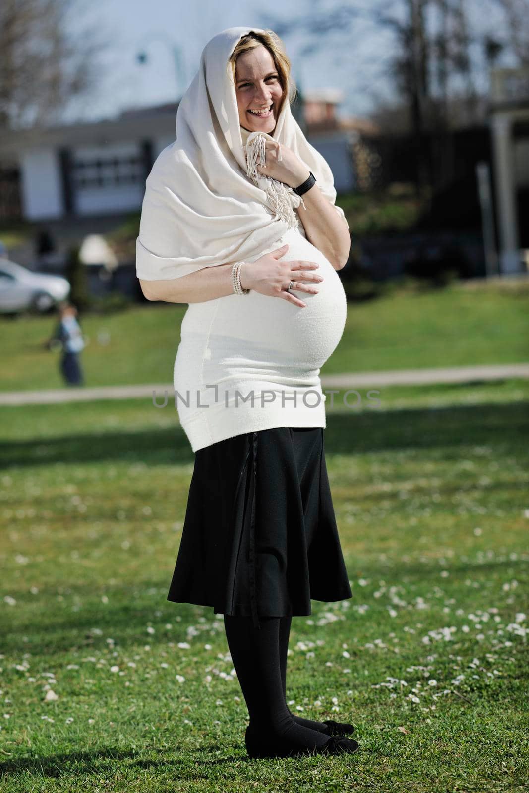 happy young pregnant woman outdoor by dotshock