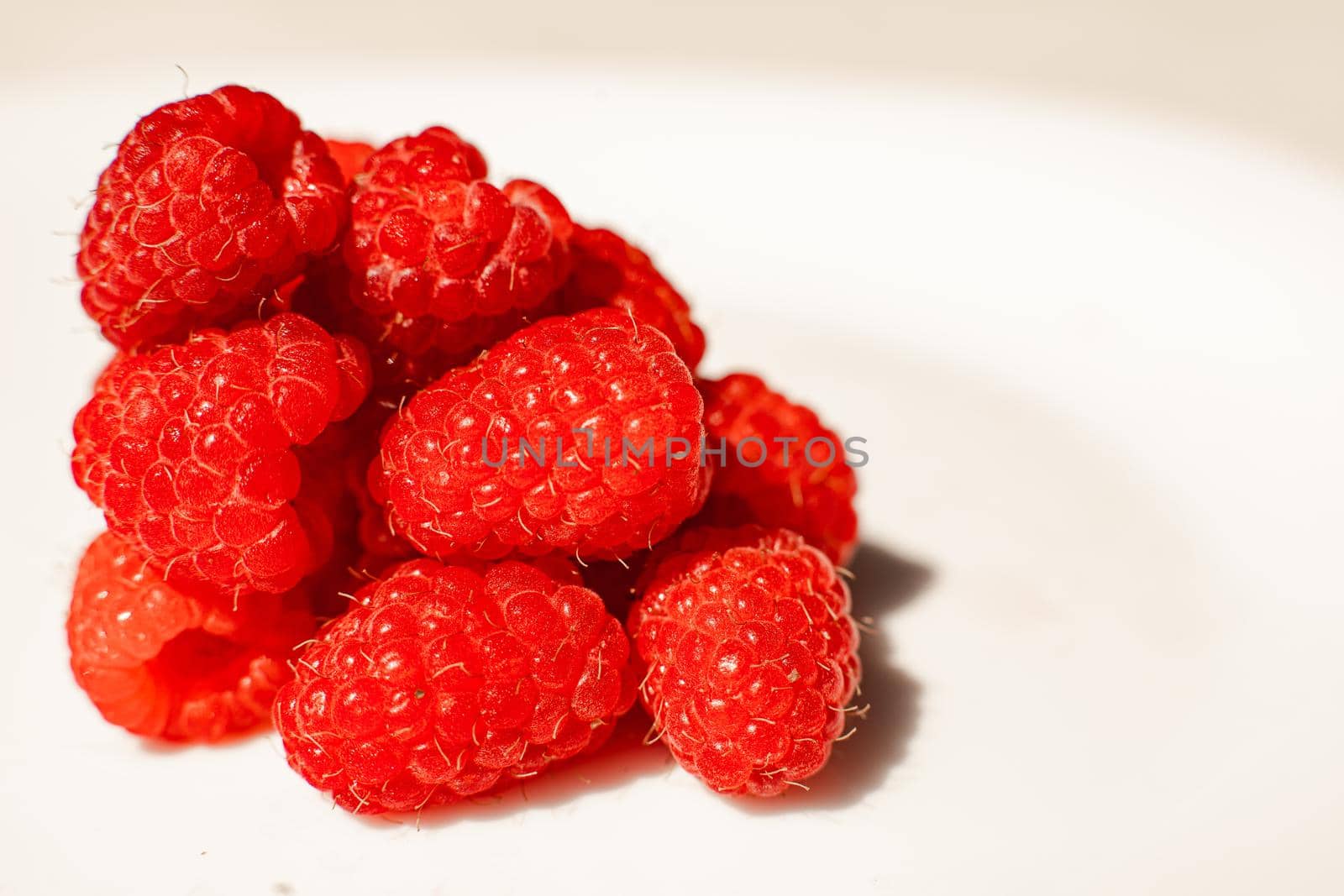 Beautiful raspberries isolated on a white background. Cut out, close up. Background and picture for postcard by StudioLucky