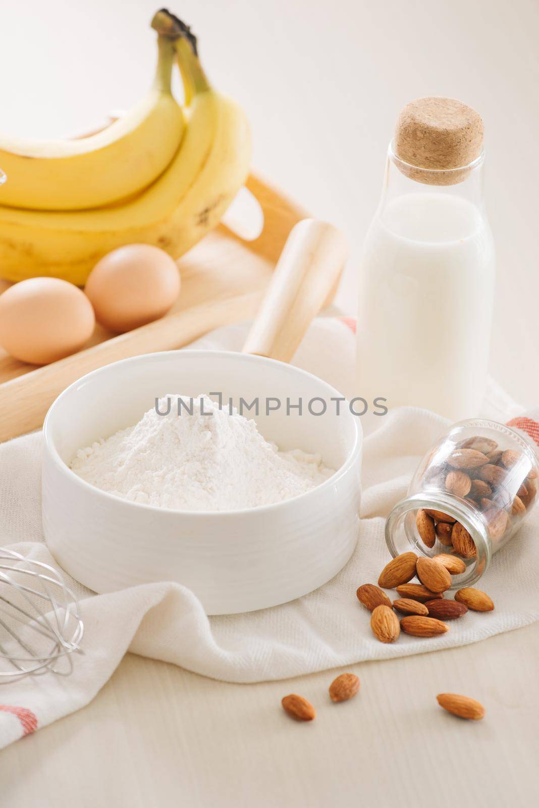 ingredients and tools to make banana cake on white background by makidotvn