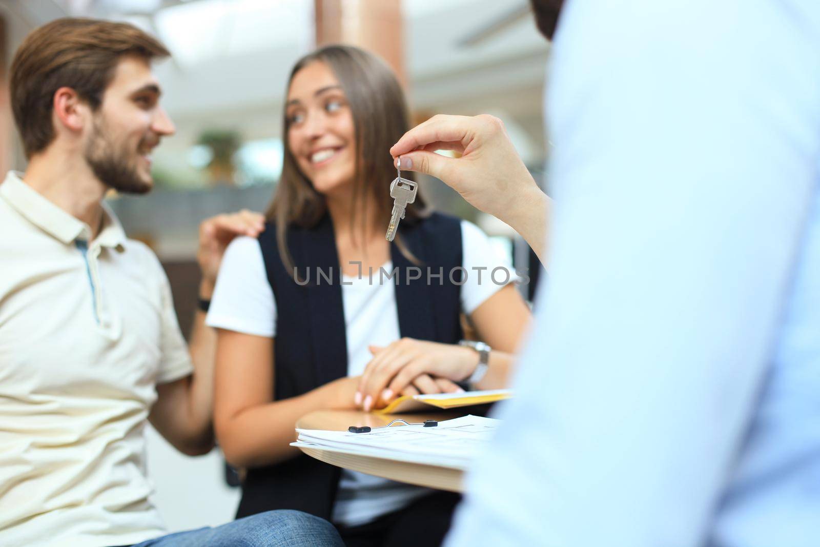 Successful lawyer giving consultation to family couple about buying house.