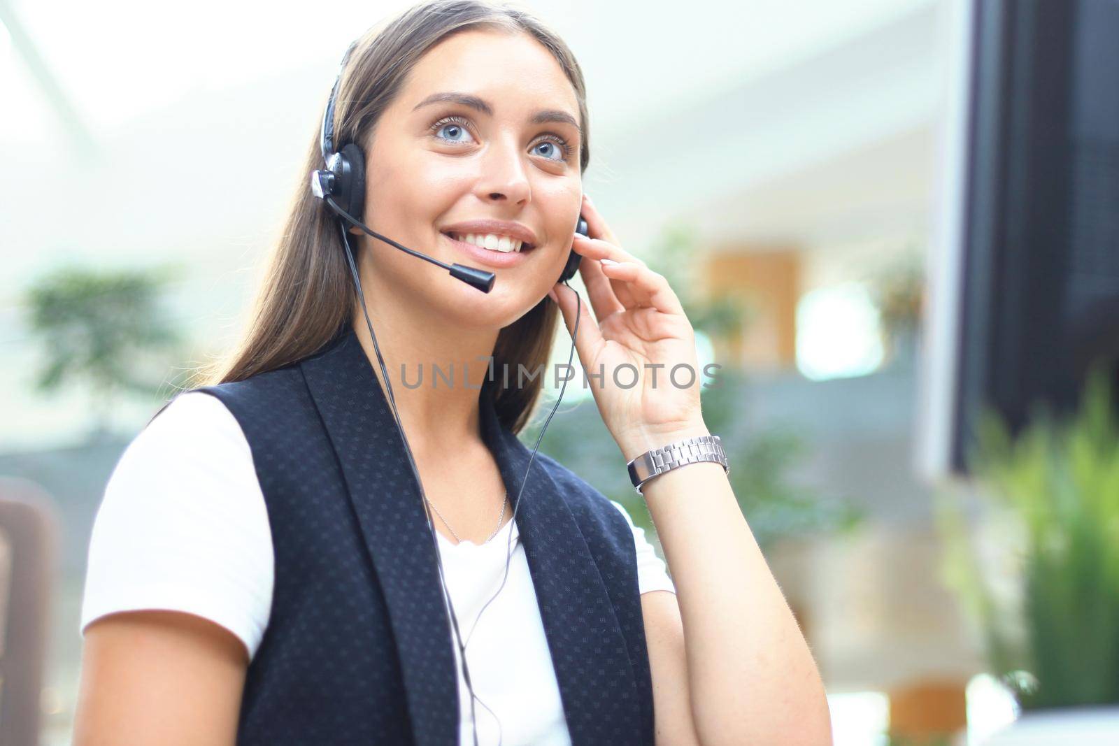 Woman customer support operator with headset and smiling