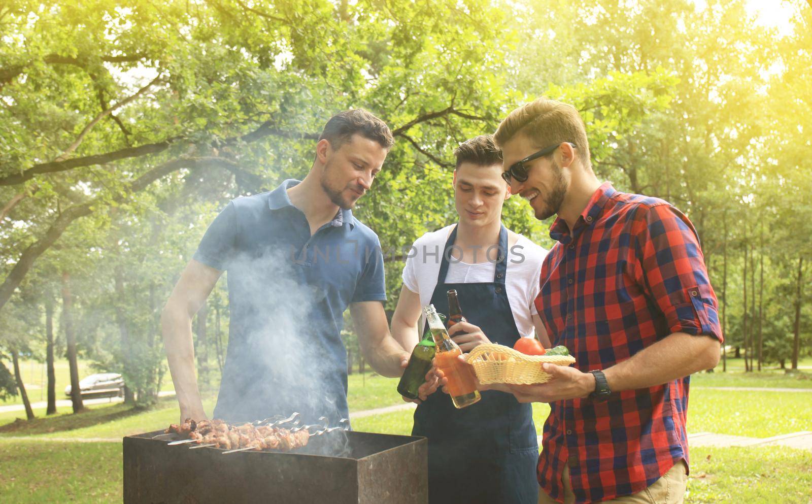 Friends spending time in nature and having barbecue