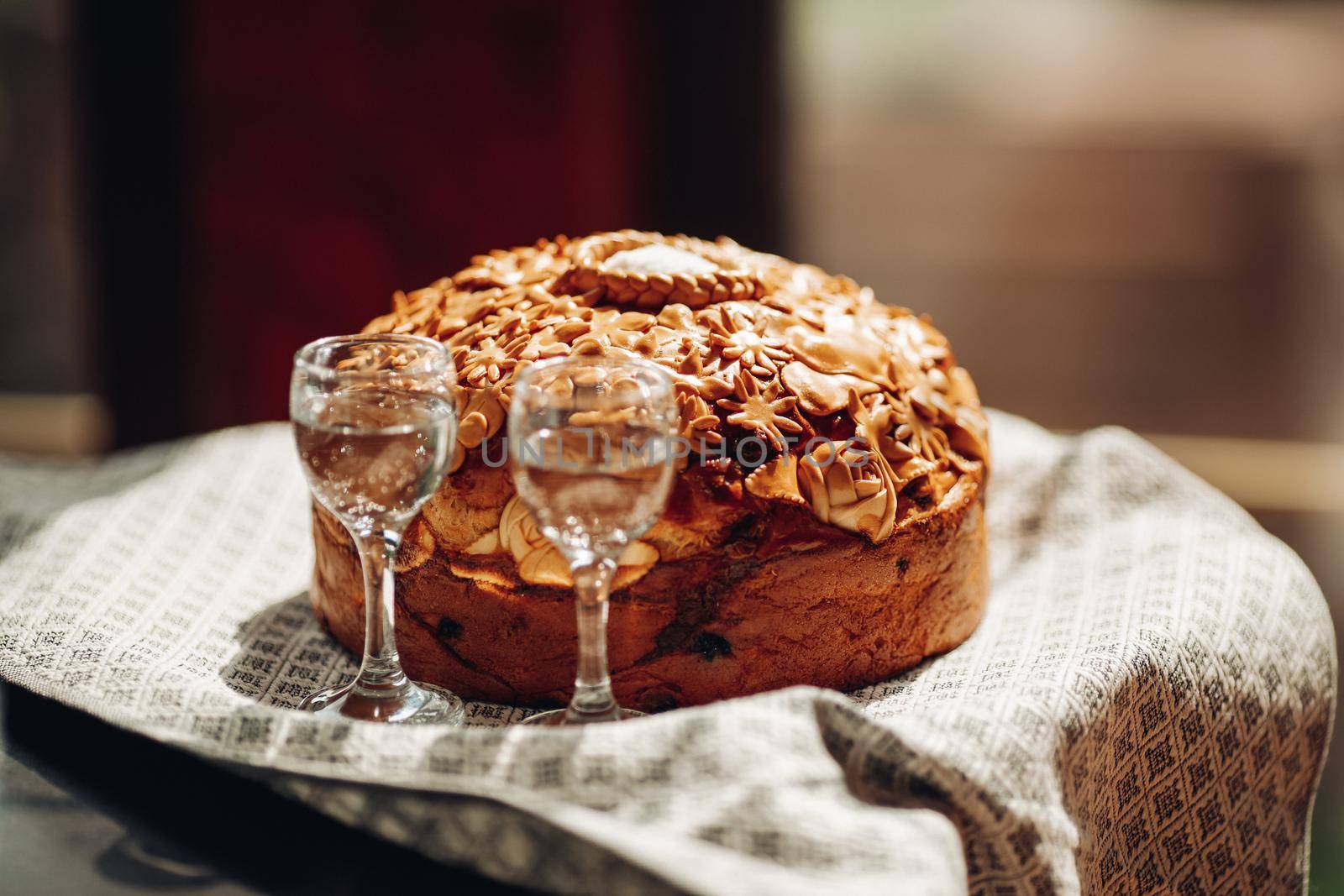 picture of big delicious wedding loaf with two blocks of alcohol in the morning sunlight