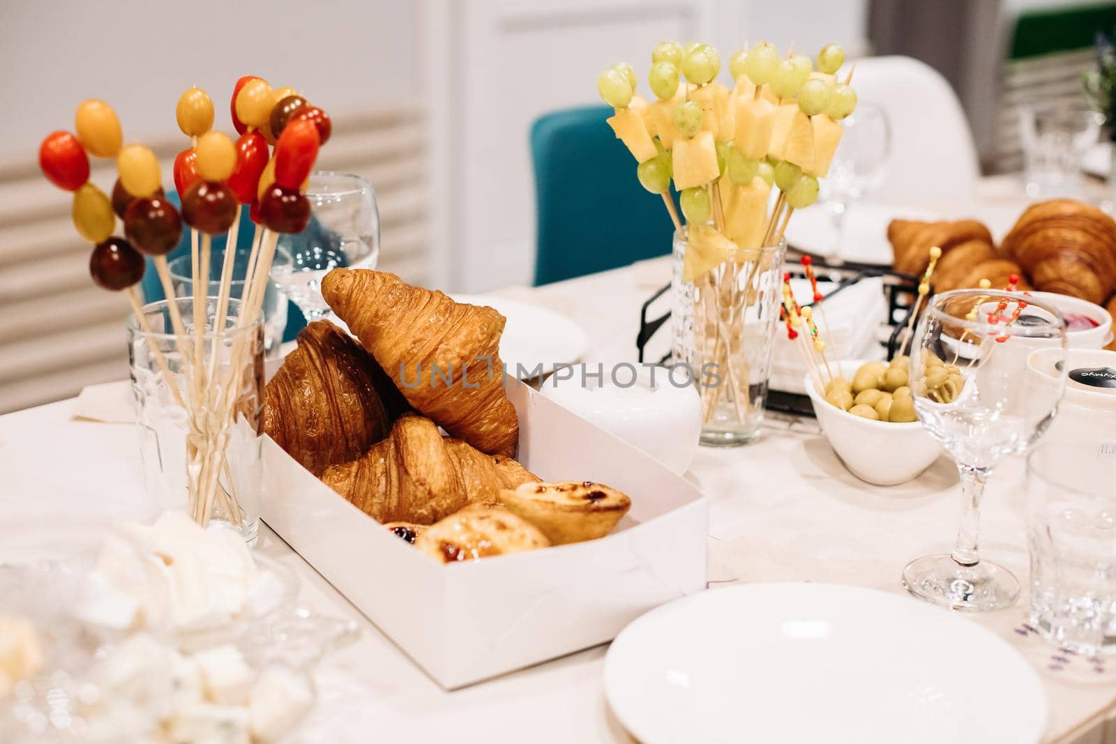 Party catering. Festive dinner table setting with canapes, croissants, different snacks for celebrating event. High quality photo
