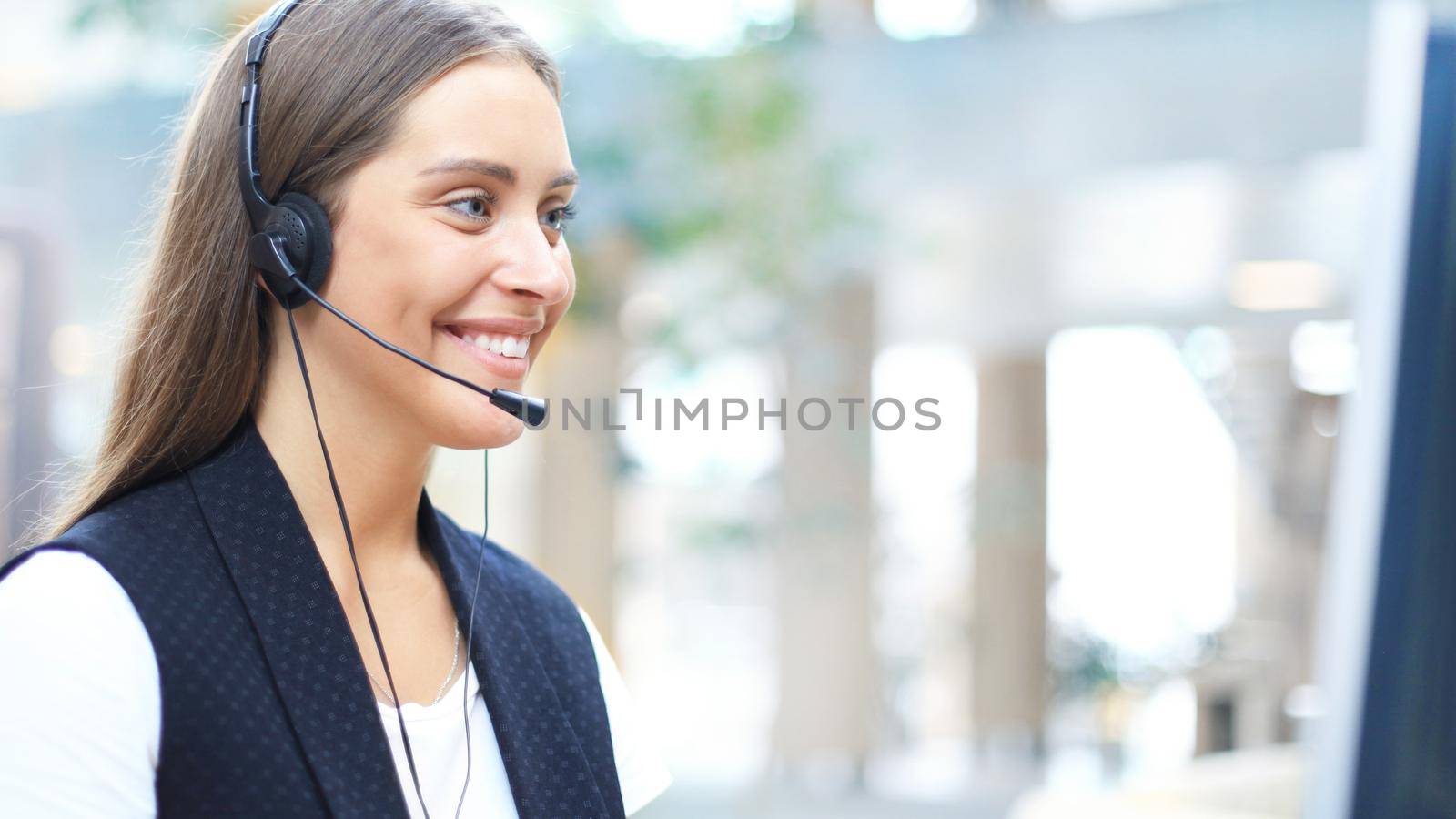 Woman customer support operator with headset and smiling