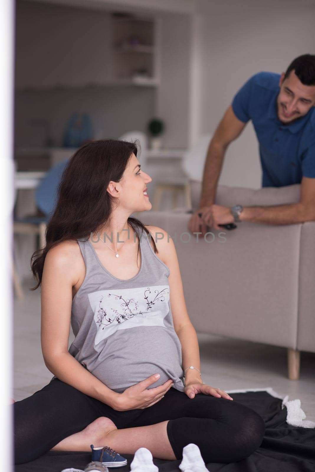 pregnant couple checking a list of things for their unborn baby by dotshock