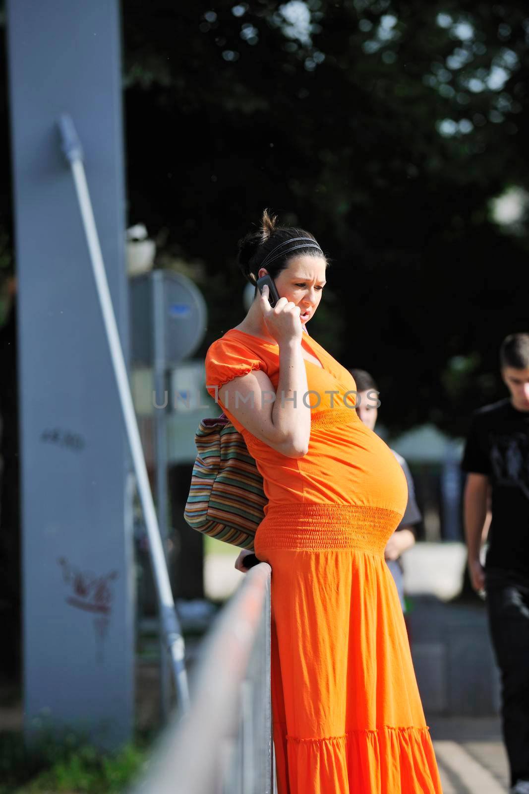 happy pregnant woman talking by cellphone by dotshock