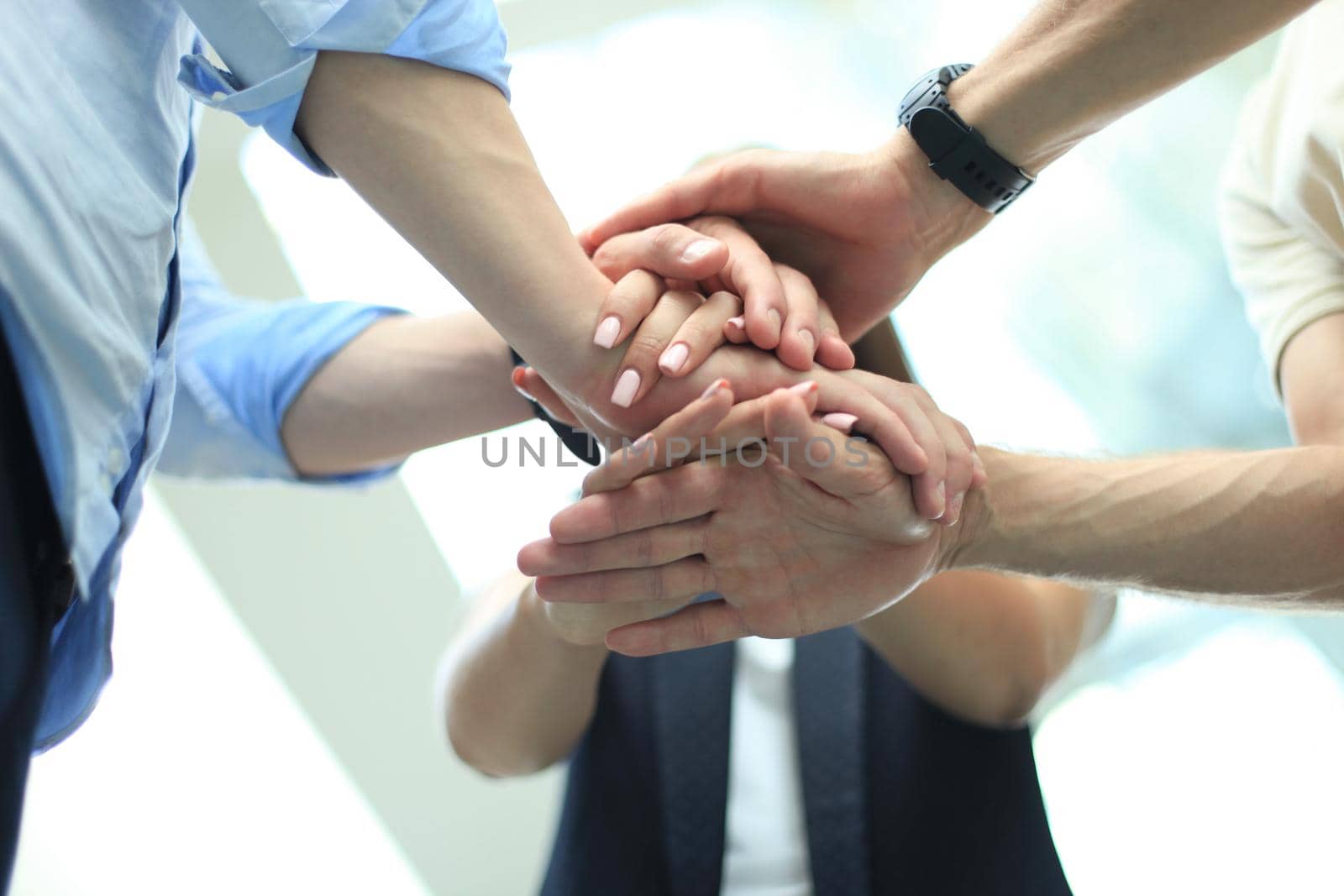 Group of businessman team touching hands together. Selective focus.