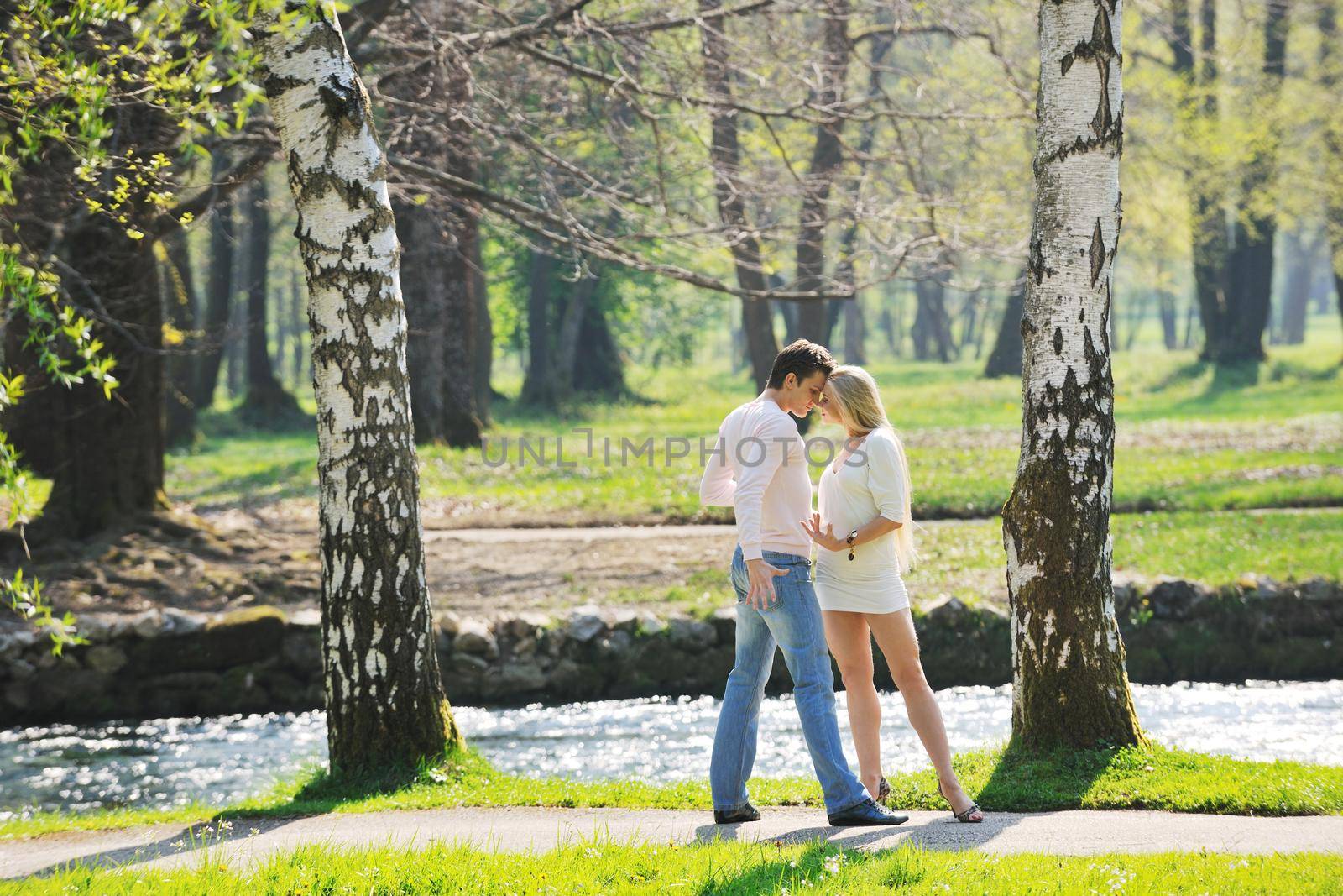 happy young romantic couple in love dance outdoor at spring season on early mornig with beautiful light