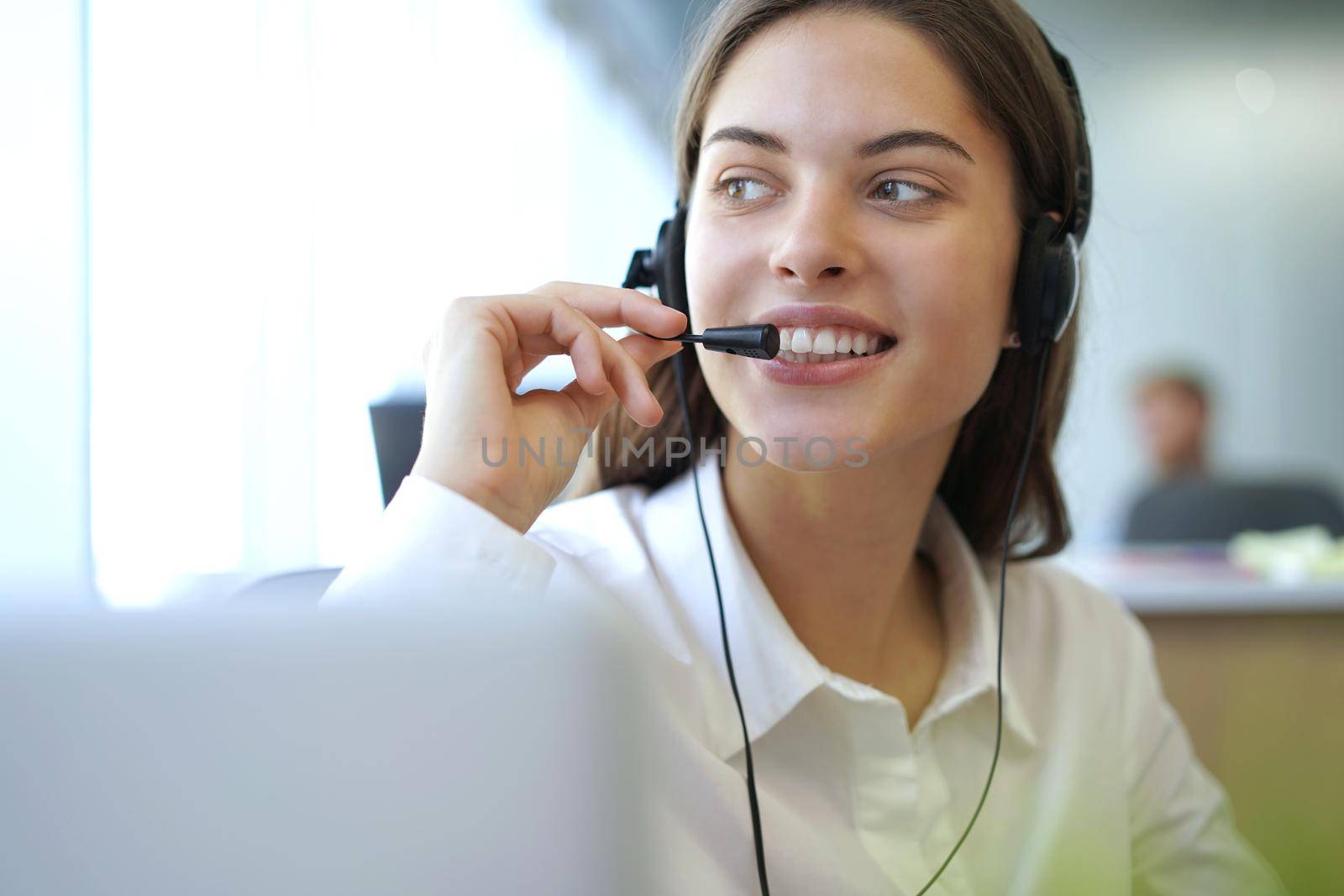 Customer support operator working in a call center office.