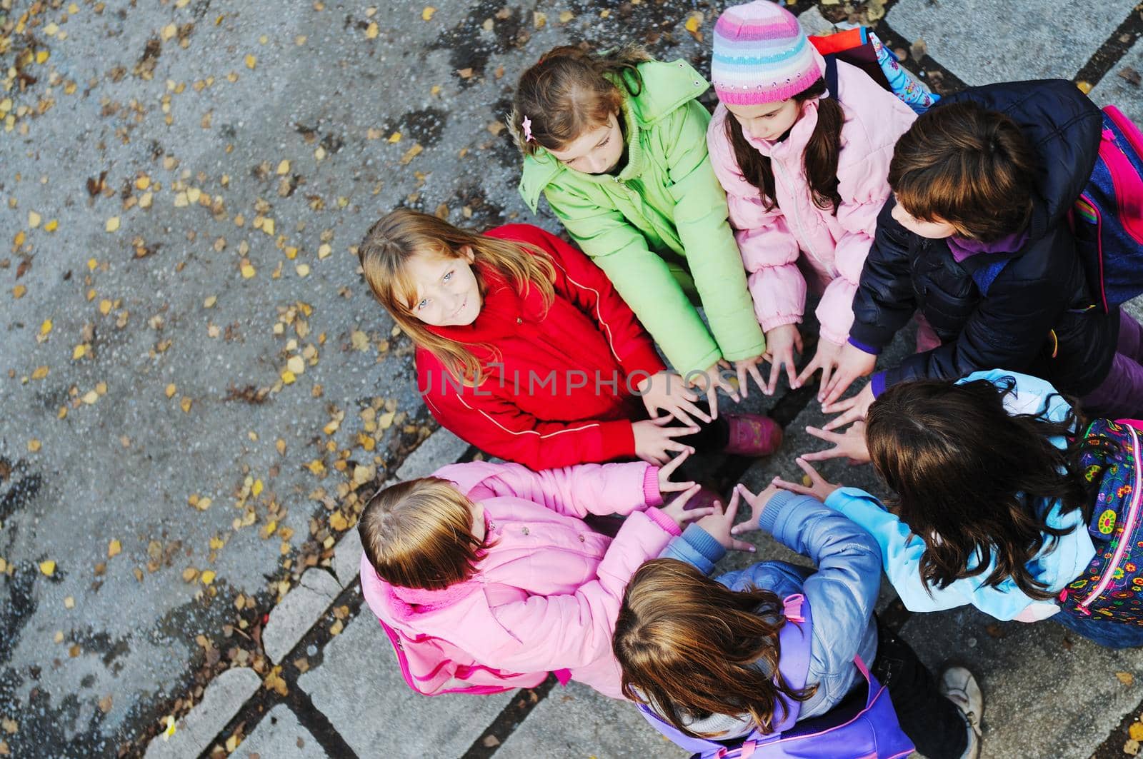 friendship and teamwork concept with young schoolgirls group by dotshock